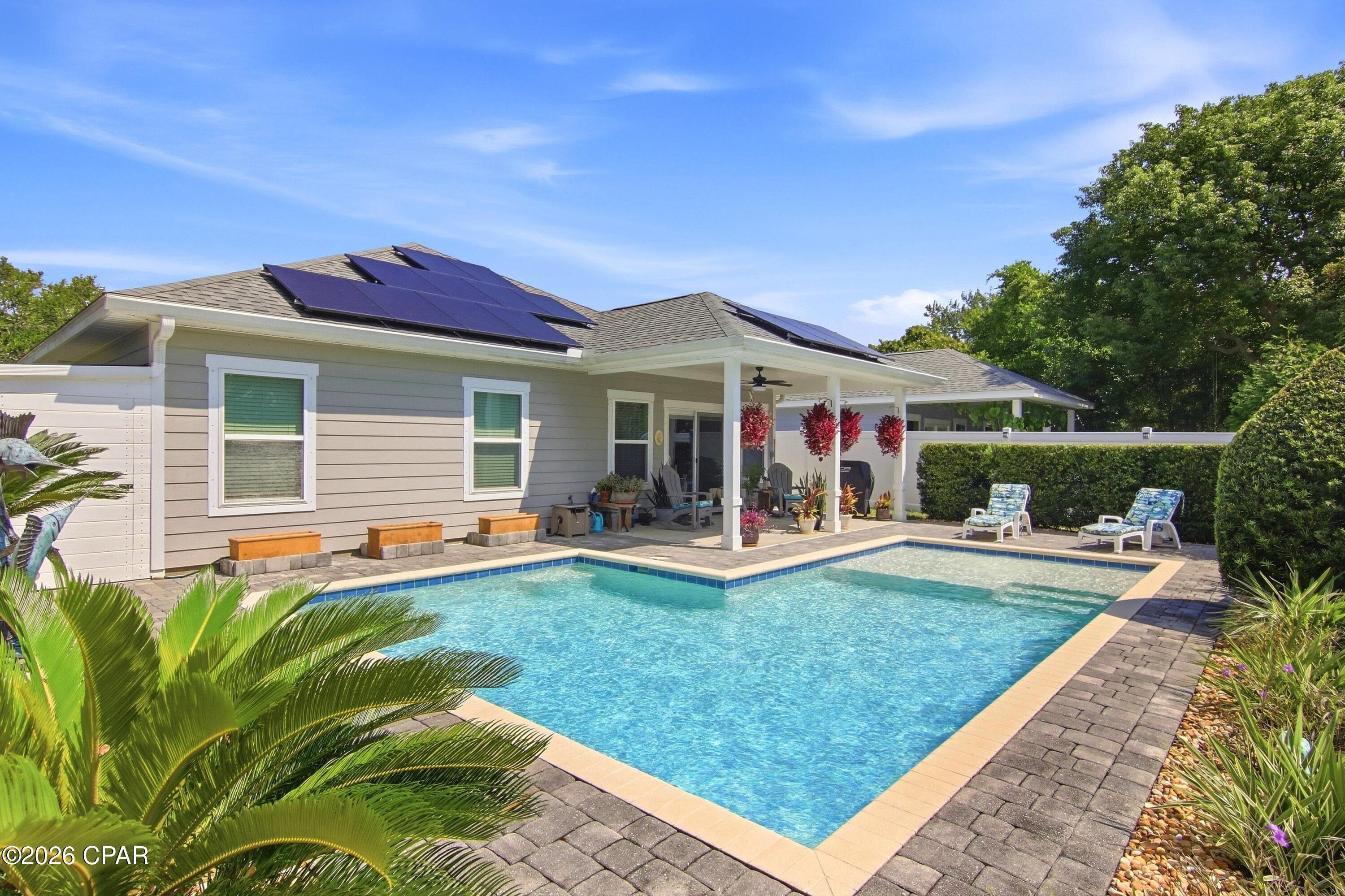 Welcome to 136 Porter Dr., where your own private backyard retreat awaits in the heart of Panama City Beach--with NO HOA! This beautifully maintained, one-owner home is designed for enjoying the Florida lifestyle, featuring a sparkling saltwater pool, covered lanai and white vinyl-fenced backyard--the perfect setting for relaxing, entertaining and soaking up the sunshine.

Inside, the home offers 1,792 square feet of open-concept living with 3 bedrooms and 2.5 baths. Tile flooring throughout and granite counter tops provide a stylish, low-maintenance interior ideal for easy coastal living. The spacious living room features a tray ceiling and flows directly onto the covered lanai, creating a seamless connection between the indoor living space and the pool and backyard.

The generously sized primary suite features a luxurious tiled bath with double-sink vanity, walk-in shower, soaking tub and an impressive walk-in closet. Two additional guest bedrooms share a convenient Jack-and-Jill bath.

Additional features include solar panels, an irrigation system serving both the front and back yards, Kevlar hurricane protection for the windows and a Pristine Air Bioforce Defender Germicidal UVC system mounted on the duct work. This whole-home UV air purification system is designed to help reduce airborne and HVAC-system contaminants, including mold, bacteria, viruses and odors.

The location is another standout feature! Situated adjacent to Frank Brown Park, the neighborhood offers its own neighborhood golf cart path providing convenient access to the park. Enjoy nearby amenities including the Aquatic Center, tennis and basketball courts, playgrounds, dog park and skate park, along with access to Gayle's Trails that connect to the Conservation Park.

With NO HOA, a private saltwater pool, solar panels, inviting outdoor living space and an exceptional Panama City Beach location, 136 Porter Dr. offers a combination that's hard to find!