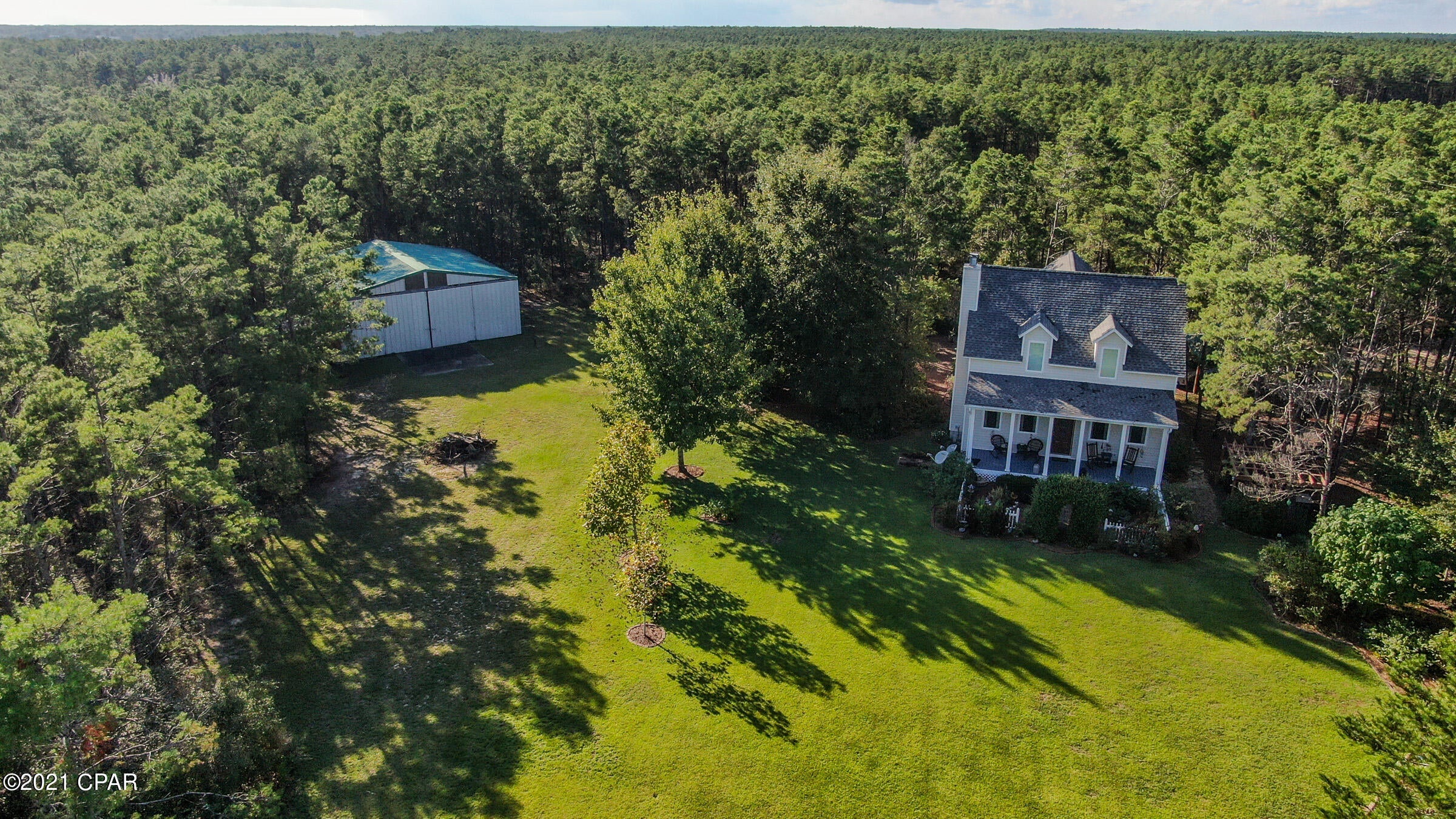 Beautiful two story country home facing the airstrip in Crystal Lake Air Park.  This home has been meticulously maintained and updated since it was first built in 2000.  The home has a large front porch that faces a beautifully landscaped yard and the airstrip beyond.  If you're ready to park your aircraft the seller has erected a 40' x 36' hangar with a 38' opening.  The hangar can also be rented out to another aircraft owner if you'd rather.  This is a 3/2.5 with the master bedroom on the first floor and two additional bedrooms and a loft and office on the second floor.  The home boasts hardwood flooring on the first floor and berber carpeting on the second floor. A laundry room/mudroom is your access to the kitchen form the back porch. Consider the following features when viewing this listing:  2x6 studs in the walls, subfloors using two sheets of 1" plywood glued and screwed, 10' high ceilings on the first floor, new outdoor porch fans, a special plug in the outside electrical box so the gas generator can provide water, refrigerator and lights in case of a power outage, all utility lines are underground.  For your aviation folks, airport ID is 2FLO and local comm frequency is 122.970