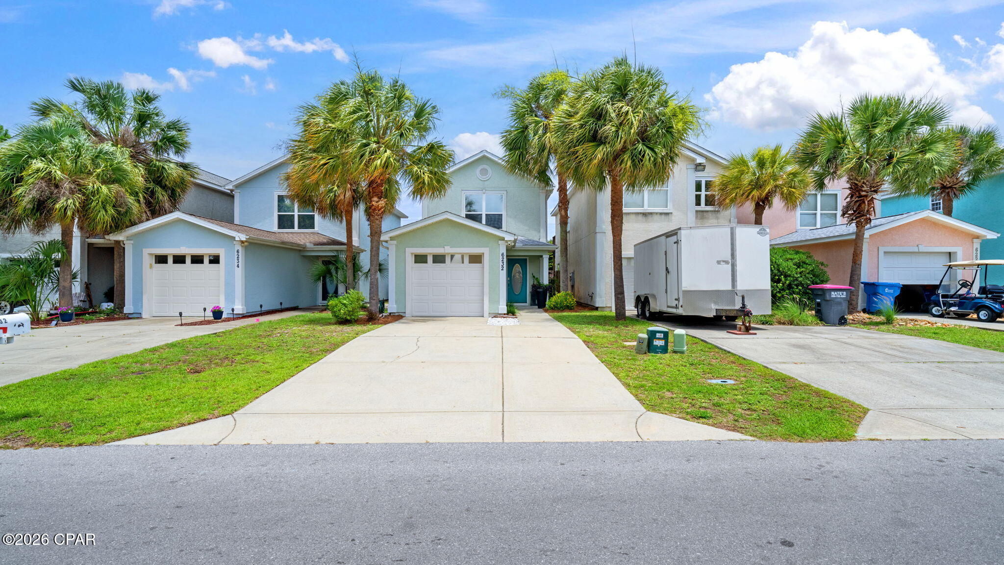 COMPLETELY RENOVATED BEACH STUNNER!  Every detail has been reimagined to create a modern, warm, move in ready experience!  Lovingly cared for and no detail left out, completely redone in 2026.  Feel the warmth of high end LVP flooring in warm inviting tones throughout.  The clean smooth ceilings highlight all new recessed lighting with designer fans and crystal pendants and flush mount chandelier complete with dimmers. The kitchen boasts undercab lighting with cool to warm CCT color switch to choose your mood. The chefs kitchen features top of the line quartz countertops, new sink, faucet and stunning Spanish tile backsplash. Upstairs is no exception with gorgeous wood beams on the landing ceiling, a  bathroom with dual sinks and  linen closet and lighting fixtures in master and second bedrooms.  The expansive balcony off of the Master Bedroom overlooks the luscious backyard for easy relaxing with coffee or your favorite beverage.  The backyard is full of edible fruit trees to include: pomegranate, apple, avacado, grapefruit, banana, loquat and peach!  Off of the grilling porch downstairs, there is a raised vegetable garden as well! A Ring camera with flood lights and doorbell camera will protect your piece of paradise.  All of this and only 10 minute drive to the beach and 5 minutes away from Grand Lagoon with wonderful restaurants (like Captain Andersons, Deckhand Social and Grand Marlin), grocery stores and shopping!  Don't miss this beauty.  Call for your personal showing today.
