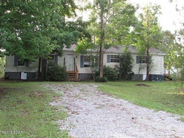 Doublewide sits on a lovely, wooded lot and offers plenty of privacy.  Interior features an ''L'' shaped living/dining area w/corner fireplace, separate kitchen w/breakfast area and utility room, and 4 spacious bedrooms including a master suite w/full bathroom. There's work to be done here for sure but it's a great location for the outdoor lover, so well worth the work. Wow, this home is a block away from Deer Point Lake, so bring the boat! EQUAL HOUSING OPPORTUNITY.