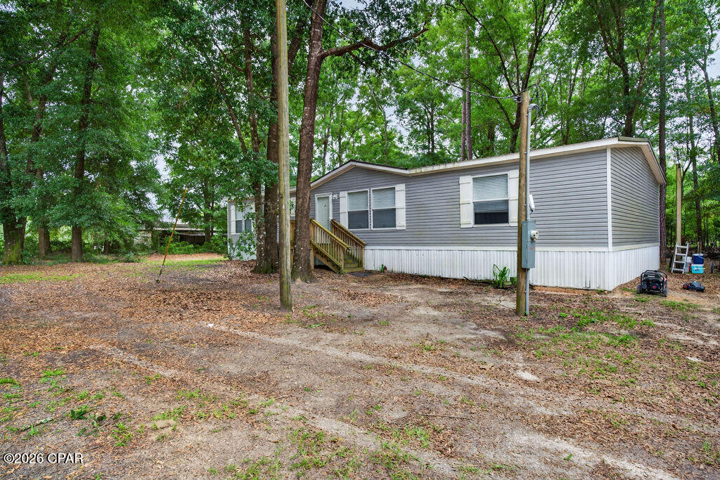 Welcome to this well-maintained 2022 double wide mobile home situated on 1.7 acres at the corner of Creek Road and Acuff Road. This 3-bedroom, 2-bathroom home offers a comfortable layout with plenty of room both inside and out. The main living area is open to the kitchen and dining space, creating an inviting setup for everyday living and entertaining. The nice-sized kitchen features ample workspace, and a kitchen island, making it both functional and welcoming. The master bedroom features a spacious attached bathroom with a nice-sized shower, double vanity, and a separate vanity space, creating a functional and inviting retreat. Step outside and enjoy your own private outdoor oasis featuring a fenced 2010 gunite in-ground pool, perfect for relaxing or entertaining during the warmer months. The property also includes a spacious 3-car detached carport, offering plenty of covered parking and storage space. With two septic systems already in place, this property provides added flexibility and potential for future use, subject to county approval. Conveniently located with room to spread out, this property is a wonderful opportunity for those looking for space, comfort, and outdoor enjoyment.