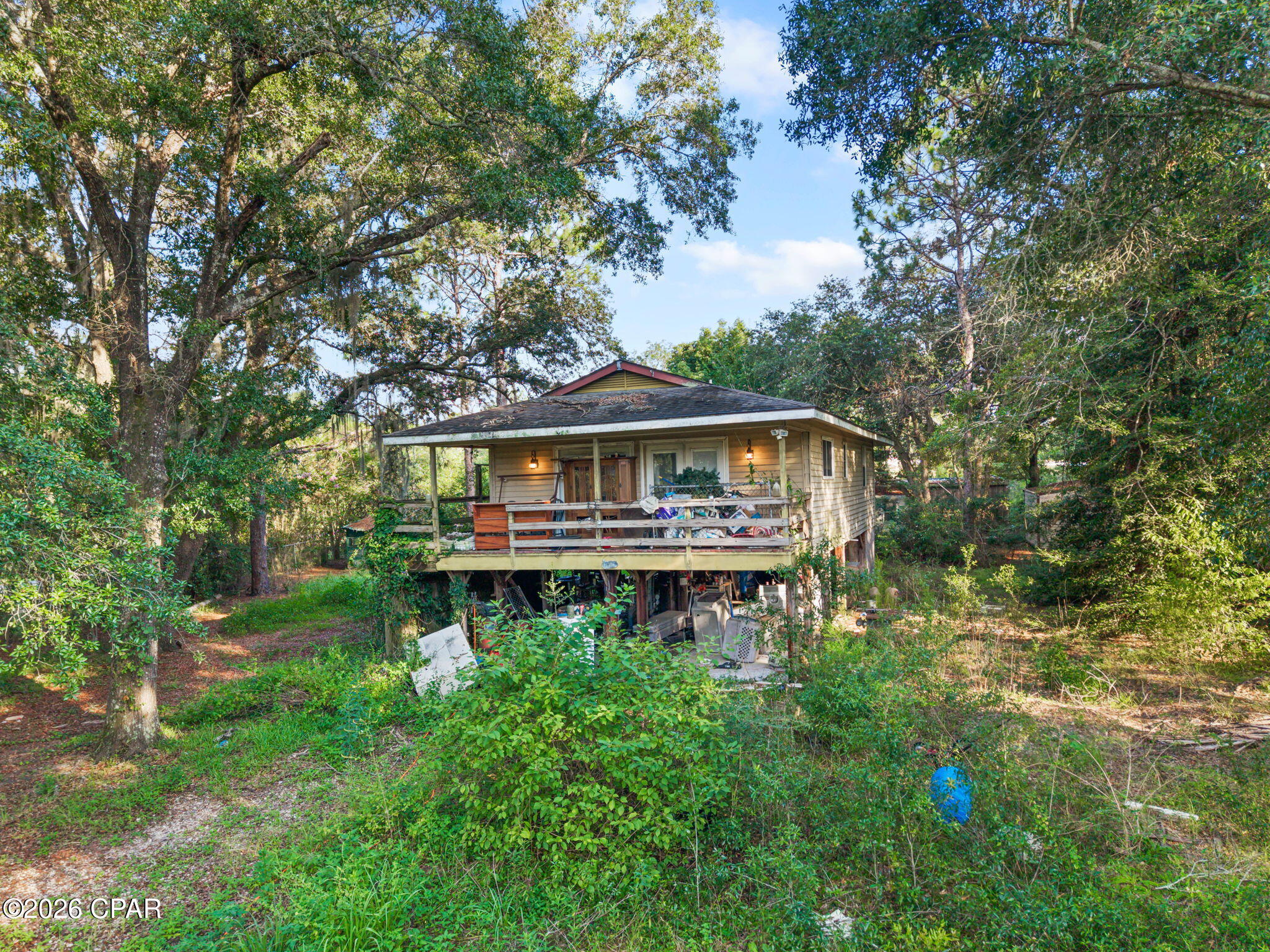 Investment Opportunity on 5+/- Acres! Unlock the potential of this 2-bedroom, 1-bath home situated on approximately 5+/- wooded acres. Whether you're an investor, flipper, or buyer looking for your next renovation project, this property offers the space, privacy, and upside that's becoming increasingly difficult to find. The home features an open-concept living, dining, and kitchen area, two generously sized bedrooms, a dedicated utility room, and a large covered front porch overlooking the peaceful surroundings. While the home is in need of updates and repairs, it provides an excellent opportunity to renovate, rent, resell, or create a private getaway. Adding even more value is the 20x20 detached garage/workshop, offering ample space for storage, equipment, or hobbies. The expansive 5+/- acre parcel provides endless possibilities, with room for recreational use, additional structures, or future improvements. If you've been searching for a property with acreage and privacy, this is one you won't want to miss. This is an outstanding opportunity to transform a rural property into a profitable investment or a peaceful country retreat.