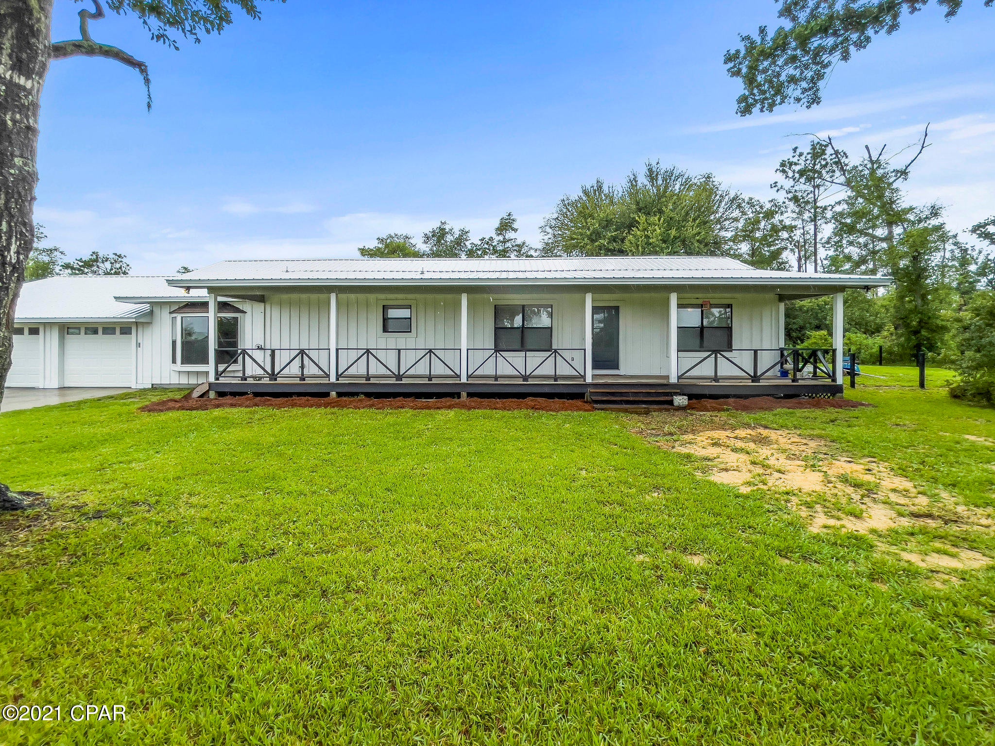 Enjoy the quiet life in this beautifully upgraded home on almost 5 acres! The relaxing front porch is 54x7 ft. and back porch is 18x8 ft.   Home is a spacious 3 bedroom 2 bathroom with bonus room. Some of the upgrades on this home included  stainless steel appliances and renovated bathrooms. Other upgrades are new metal roof in 2020, new tile in bathrooms and den.  New garage door openers 2020. New underground well pump 2019. New septic tank in 2017. Underground power and water is available to barn.  New Zoysia turf (14 pallets) in back yard 2020. New crushed concrete driveway 2021. 

All sizes are approximate and should be verified.