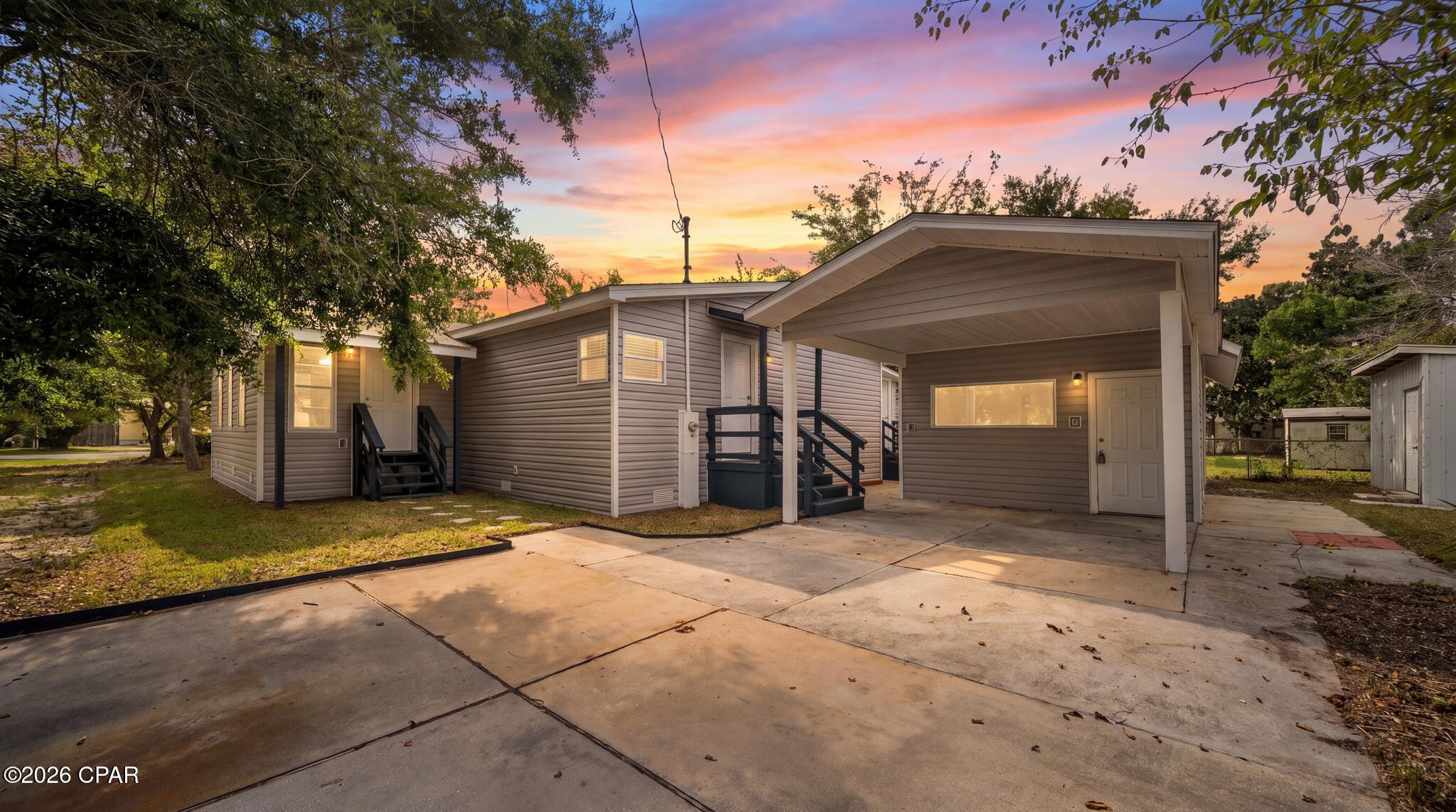 Located on Westwood Beach Circle on the west end of Panama City Beach, this fully renovated property offers more than 2,400 square feet of total indoor living space with 5 bedrooms and 4 bathrooms overall. The main residence features 4 bedrooms and 3 full bathrooms, while the detached split-level studio provides an additional bedroom and bathroom, creating a flexible setup for a primary residence, second home, or short-term rental. Just minutes from Lake Powell and within convenient driving distance of the beaches of Panama City Beach and the communities along 30A, the property offers easy access to coastal recreation, dining, shopping, and entertainment. Inside the main residence, extensive renovations include new drywall with a knockdown finish, fresh interior paint, updated baseboards, doors and trim, and LVP flooring throughout. The remodeled kitchen features granite countertops, stainless steel appliances, new cabinetry, and an open connection to the den, where a wood-burning fireplace creates a comfortable gathering space. One of the four bedrooms in the main residence features its own exterior entrance, adding privacy and flexibility for guests. Additional living spaces include a sunroom, dining area, and flex space that can accommodate a second seating area, game room, office, or additional sleeping arrangements. The laundry room offers ample storage and folding space, adding convenience for everyday living, extended stays, and guest turnover. The primary bathroom has been fully renovated and features a tiled shower with glass doors, soaking tub, and double vanity. Additional improvements include a recently installed HVAC system, new water heater, and new roof. The detached split-level studio adds another layer of versatility to the property and includes a full bathroom, mini refrigerator, and space for sleeping and living furniture. This separate space is ideal for guests, extended stays, a private retreat, or additional rental accommodations. Exterior updates include new vinyl siding, fresh sod, an outdoor shower, and a storage shed ideal for beach gear, kayaks, property supplies, or an owner's storage area. A gazebo provides an additional outdoor space for relaxing and enjoying the coastal setting. With a 4-bedroom, 3-bath main residence, a detached 1-bedroom, 1-bath studio, more than 2,400 square feet of total indoor living space, extensive renovations, and a convenient west end Panama City Beach location near Lake Powell and 30A, this property offers exceptional flexibility for a variety of uses. Call a REALTOR® today to schedule a private tour. If important, please verify all measurements, square footage, rental eligibility, and information.