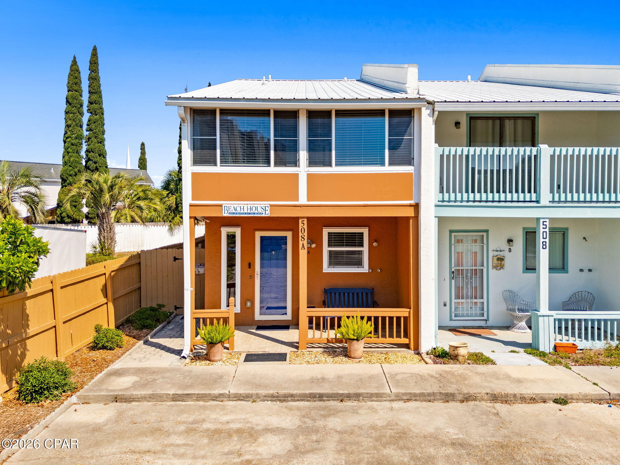 CURRENTLY UNDER CONTRACT, SELLER WILL CONSIDER BACKUP OFFERS.         VERY MOTIVATED SELLER!!!     Walk to Beach Access 65! -- no HOA and short-term rentals allowed! Just 0.2 miles from Beach Access 65 and minutes from Pier Park, Frank Brown Park, Harley Davidson, Shopping galore, restaurants and grocery; this 2BR/1.5BA townhouse is a turnkey investment, second home, or primary residence in one of PCB's most vacation-rental-friendly neighborhoods.
     Major updates from 2022-2024 include a new A/C, hot water heater, range, dishwasher, washer/dryer, all new slider doors in the living room, master, and guest bedrooms, and fresh paint throughout -- inside and out, walk-in shower w/seat, master vanity & toilet, microwave, garbage disposal, living and bedroom draperies, new garden shed, printer, Venetian blinds at front & back porches, impact kitchen and foyer windows and an enclosed back porch w/storm door & windows!  Outside, enjoy a fully redone yard, new wooden deck and walkway, and a freshly repaired and painted privacy fence enclosing the back courtyard.  Everything you see in INCLUDED with the exception of the blue bench, stand, palm tree on master balcony, dining room table set, coffee table, flip desk on master bedroom balcony, and owners personal belongings!

The layout delivers two enclosed balconies, a covered front porch, a fully enclosed back patio, wood cabinet kitchen, and a laundry room. Bonus: portable generator, Blink camera system, and doorbell all convey. Rinse off at the outdoor shower and you're home -- beach life made easy.