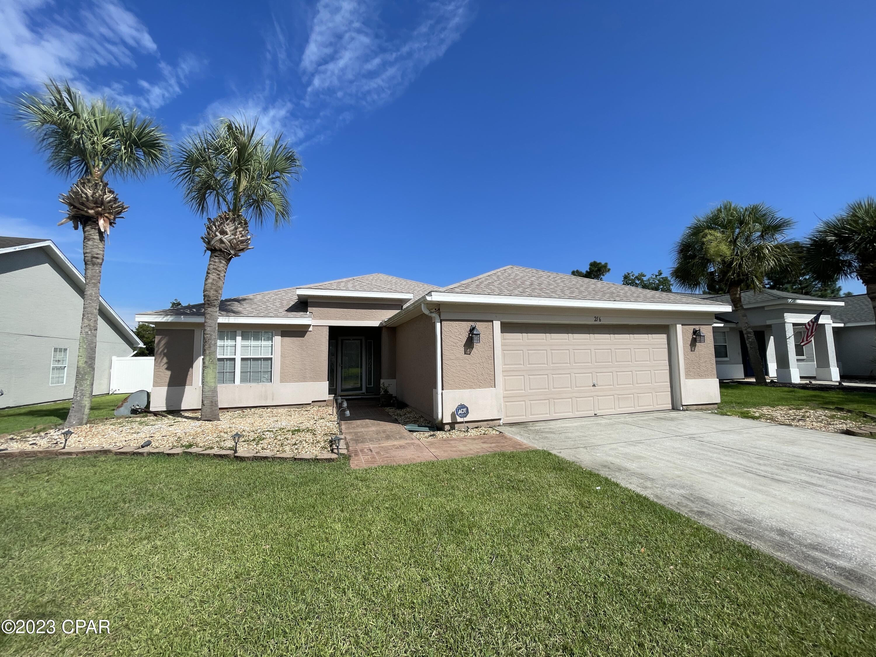 For Lease - 3 BR | 2 BA home in desirable Palmetto Trace, a golf cart community behind Pier Park with sidewalks and 2 community pools! The home features a spacious and open concept living area with wood floors and tall ceilings. The kitchen has a ton of cabinet and counter top space with all appliances including Refrigerator, Dishwasher, Stove/Oven, & Microwave. There's a kitchen island bar overlooking the dining and living room. Custom wood panel wall for TV mounting (optional). Bonus room/Formal Dining/Office of the foyer entrance; The master bedroom is on the back side of the home and has a private sliding door entry to the screened porch. Master en suite bathroom with walk-in shower, soaking tub, double vanities and large walk-in closet. Two additional bedrooms with shared hallway bathroom including a tub/shower combo; Laundry room inside leading to the Two Car Garage! Fenced backyard and slate rock patio for entertaining outdoors! **Pets negotiable with $350 non-refundable pet fee.
