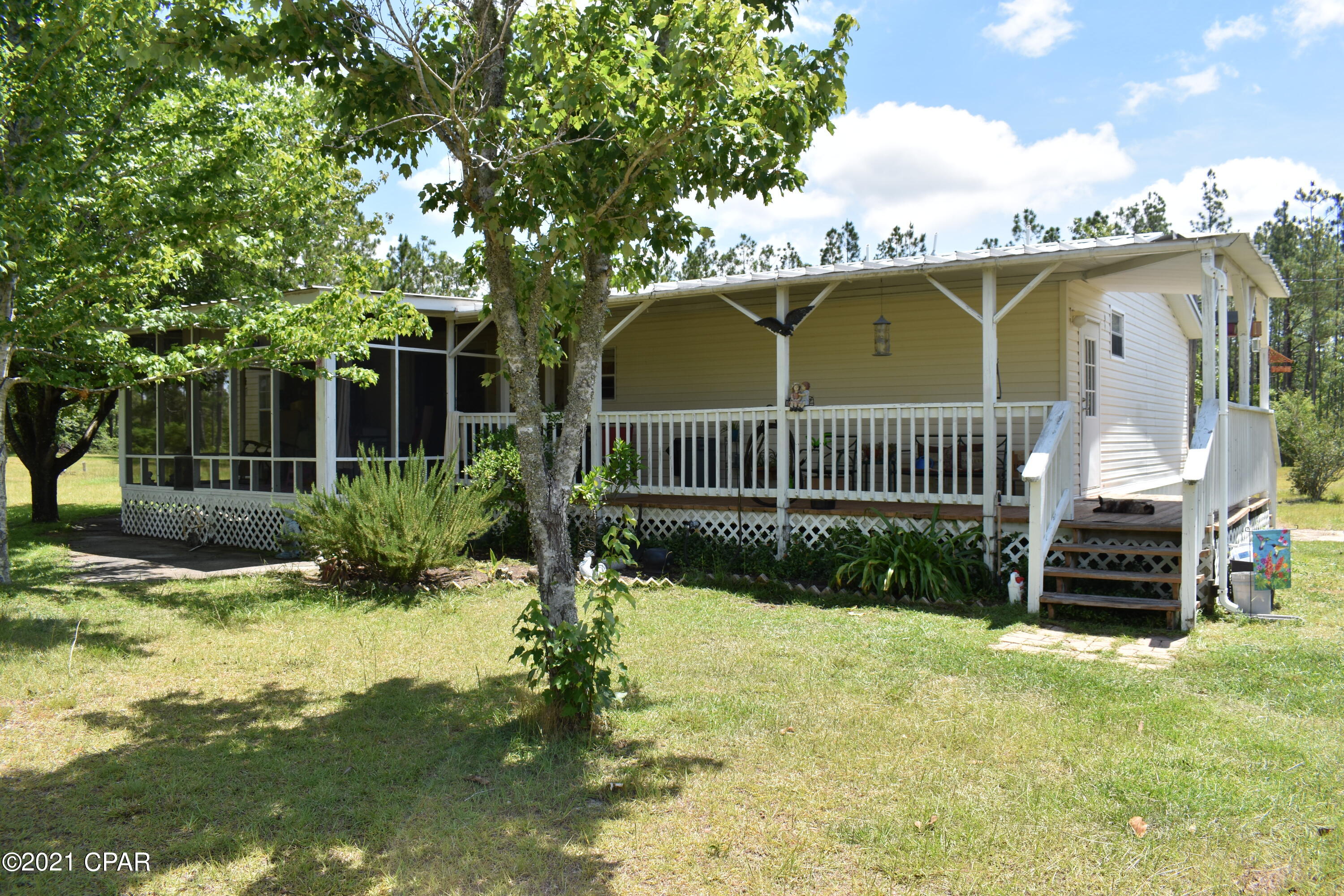Mini-Farm with ALL OF THE EXTRAS you have been looking for.   Drive through the gate and enter your own personal haven where you have plenty of opportunities all around you!  The home has been well cared for and had a roof replacement in 2019 and it has newer appliances.  You won't need to bring much as this home will be mostly furnished.  If you love gardening, nature and fishing,  you're going to really LOVE it here.  For the mechanic in the family, you can really get to work in the incredibly large 30 x 40 Quonset Hut workshop with tables and a workpit.  On the back part of the property, there is a separate septic tank, electric, 50 AMP RV receptacle, 120 outlet on power pole with weatherhead on it so that you may put a seperate dwelling (which by the way already has a 911 address). There are so many extras to include irrigation to the muscadine trees, a garden with strawberry, blueberry bushes and an assortment of vegetables to choose from.  Outbuildings include a chicken pen, covered pole barns for equipment, and an outbuilding with an extra washer and dryer set.  What are you waiting for?  Contact your favorite Realtor for a showing today!