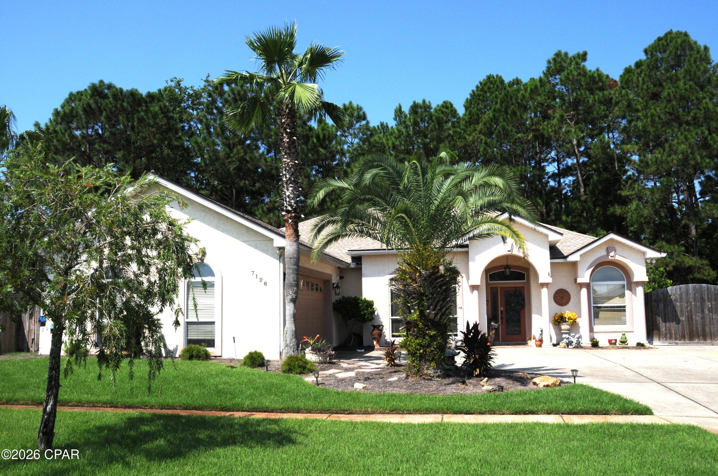 Beautiful custom home on the East End of Panama City Beach This 3-bedroom 2 bath home is loaded with upgrades! Granite Countertops, spacious Kitchen with island bar, custom built cabinets and gourmet gas cooktop. This home has a nice flow with a double-sided fireplace; surround sound built in speakers. corner unit tv and double trey ceilings with a light feature that can change mood and colors The Primary bedroom has a walk-in closet a custom soaking tub and a separate walk-in shower spacious spa like atmosphere. This home has a private enclosed 10,000-gallon saltwater pool. The outdoor living space has an outdoor kitchen with a gas fireplace and a beautiful waterfall and plenty of room for company. behind the pool enclosure is a handy workshop and plenty of storage. This home has a tank less water heater, a 2-car garage a whole house backup generator a boat pad to the side of the house. This home is located close to the bay and Panama City Beach has plenty of public access.