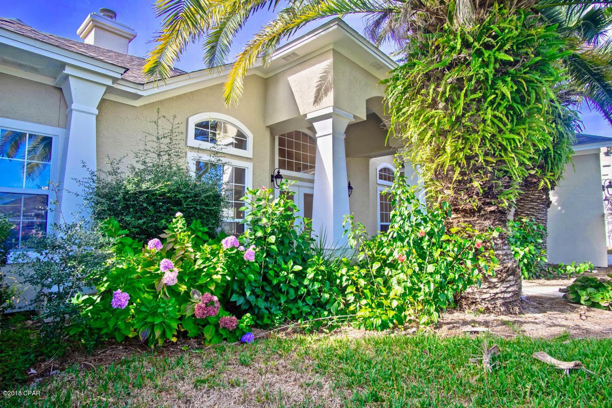 Currently under contract; seller accepting backup offers. ALL the AMENITIES for this Panama City Beach home WITH POOL are on your WISH LIST! The LOCATION is second to none. The beautiful GLADES community is situated between Hathaway Bridge and Hwy 79: convenient to Panama City, the airport, and points west. Being South of Hwy 98 places you within CLOSE proximity to the SUGAR SHORE of our INCREDIBLE BEACHES. The home is on a quiet cul-de-sac street, is ONE STORY, has FOUR BEDROOMS,  2.5 bathrooms, and  is a SPLIT BEDROOM DESIGN. Near the double-door front entrance is an OFFICE. The central living area with FIREPLACE and built-in shelving  looks out to a beautiful POOL beyond a covered and shaded patio.