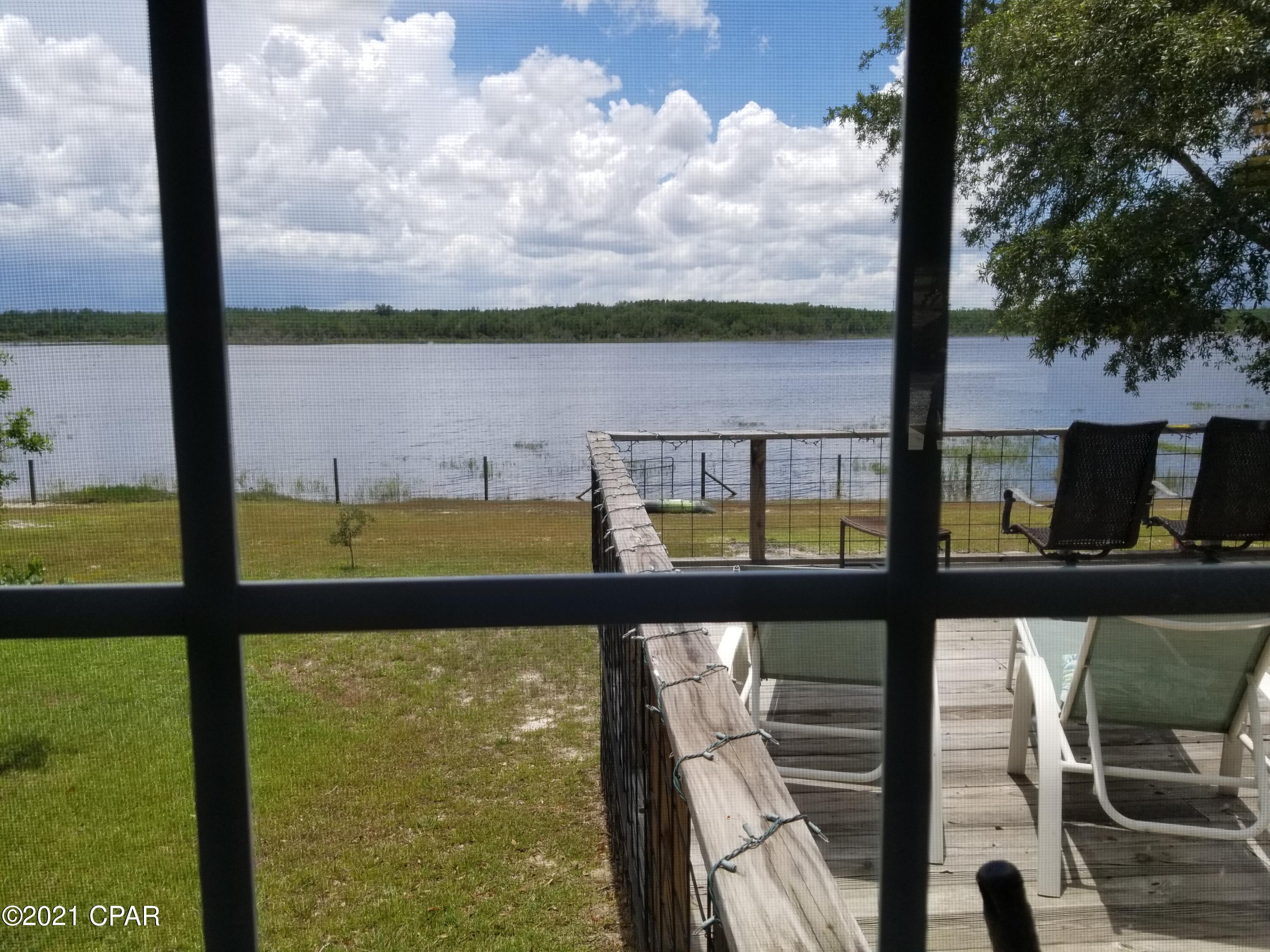 This private and secluded waterfront modern home is move-in ready for anyone hunting peace and privacy. The home took 2 years to build and has features galore. A split bedroom plan, the white kitchen with a gas cooktop and double oven is open to the the dining area and has a great view of the lake. The modern white kitchen features an electric double oven, gas cooktop and stainless steel appliances. The great room has a vaulted ceiling and the rest are 9 feet. 

The home in every detail is luxurious, from the fireplace, tile showers, soaker tub and custom finish on the walls, it is the ultimate getaway or retirement home. The huge deck is the place to be or the outdoor dining and entertainment area. The second building has surprises. See the photos and captions for more details.