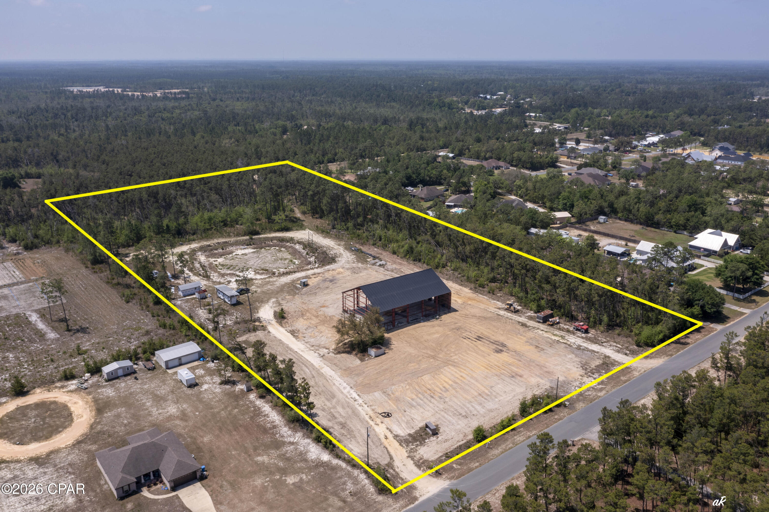 Highly Motivated Seller!  11 ACRES! Bonus! Seller will remove the existing red iron building and offer a $25,000 price reduction, creating added flexibility and opportunity for future use of the property. Rare opportunity in booming Southport! This 11-acre property offers the space, privacy, and flexibility that is almost impossible to find today. Located on a paved road with no HOA, this property gives you the quiet lifestyle people want while still being close to everything--about 10 minutes to Lynn Haven, 20 minutes to the airport, and 30 minutes to the beaches and Pier Park.
With new construction and growth expanding north, this is a prime opportunity for a private estate, family compound, or potential subdivision for multiple homes or spec builds. The property already has septic, well, power, and full camper hookups on site. There is plenty of room for your RV, boat, heavy equipment, and all the toys, plus space to create your own micro-farm with chickens, horses, goats, and more. A massive red iron building has also been started, offering approximately 14,000 square feet of heated and cooled space when completed. Permits are pulled, and a floor plan is available.
Whether you are looking for land, privacy, investment potential, or room to build something big, this Southport property is an opportunity worth paying attention to, come tour today!