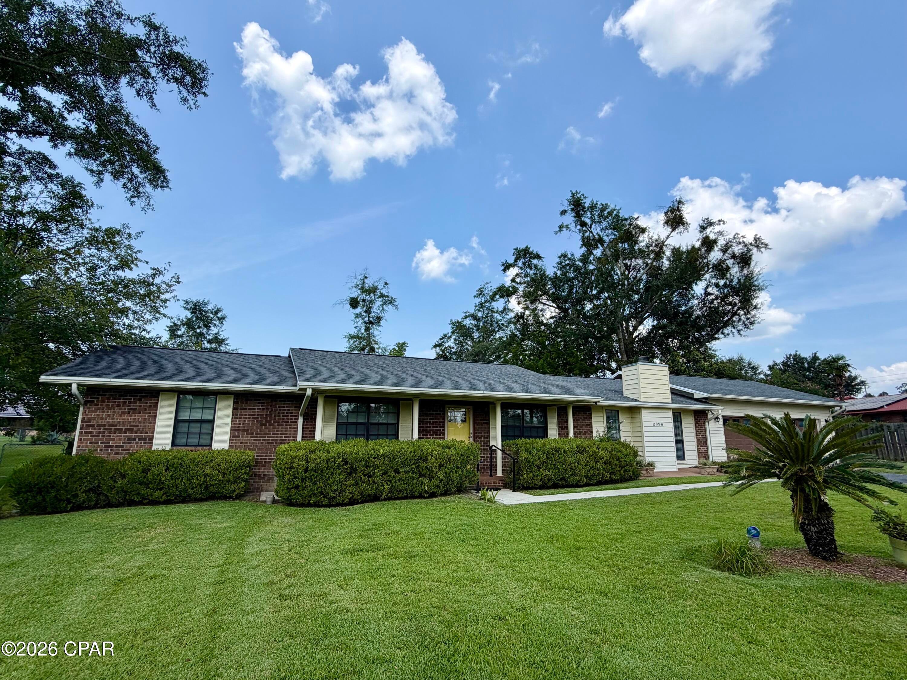 You've got to see this well-maintained brick home just outside of Marianna! This is one of those homes that simply feels like home. Offering 2 bedrooms and 2 bathrooms, there is also plenty of space and rooms to add a third bedroom.

Step through the front door into a welcoming open floor plan featuring a spacious dining area, kitchen, and breakfast area. The kitchen offers an abundance of cabinet and counter space, a convenient breakfast bar, and stainless steel appliances. French doors off the dining area lead to the living room, where a wood-burning fireplace creates a cozy ambiance during the cooler months.

Just off the breakfast area is a huge sunroom surrounded by three walls of windows, filling the space with natural light. Bahama shutters add charm and character to this inviting space. Step outside from the sunroom onto the covered patio, the perfect spot for grilling, relaxing, and entertaining.

The spacious primary suite features his-and-her closets and a large bathroom with a step-in shower. The hall bathroom, which has a door to the second bedroom, features both a step-in shower and a jetted tub!

The oversized laundry room offers plenty of room for freezers, storage, or additional workspace. There is also a large storage closet conveniently located off the garage, plus a separate storage building.

Outside, the fenced backyard is perfect for pets, children, or simply enjoying the outdoors. Beautiful landscaping surrounds the home with a variety of plants that bring back the charm and character of grandma's house.

The roof was replaced in 2018, and the HVAC system has been maintained under Jemison's service contract. A Terminix termite bond is also in place, providing added peace of mind.

This move-in-ready home has so much to offer and is ready for its new owners! Call your favorite Realtor today to schedule your private tour!