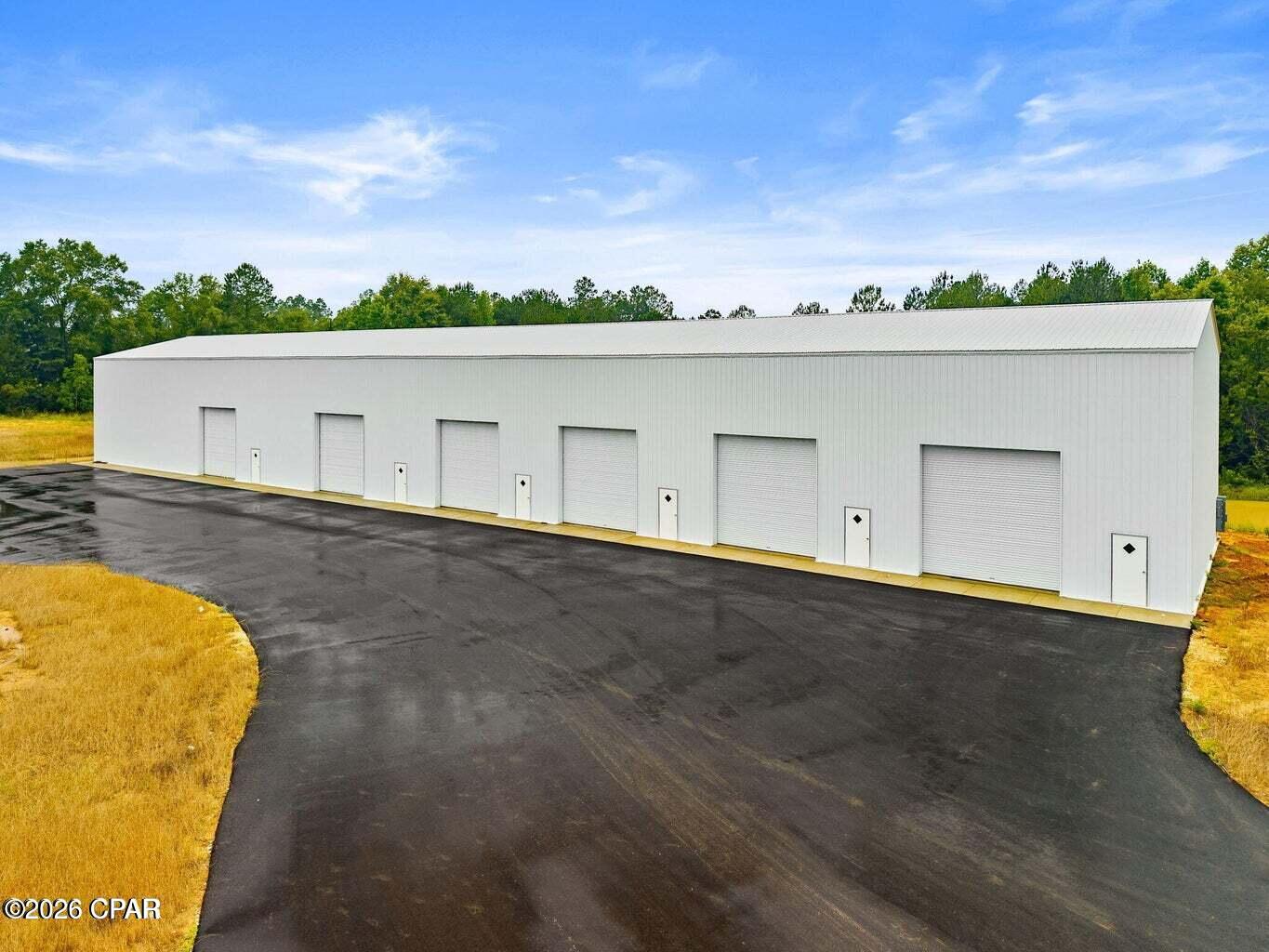 New building Complex. 10,000 sq.ft of Commercial Warehouse/ Flex space on over 7 acres. Building has six 14ft roll-up doors with 26ft roof peak and 24ft roof eaves. Configured for 6 bays, one 3,000 sq.ft bay, one 2,000 sq.ft. bay, and four 1,200 sq.ft. bays. Each bay framed for its own office, reception, and bathroom. Could be reconfigured to suit needs. Separate electric/ meter needed as well as office/bathroom finishings etc.