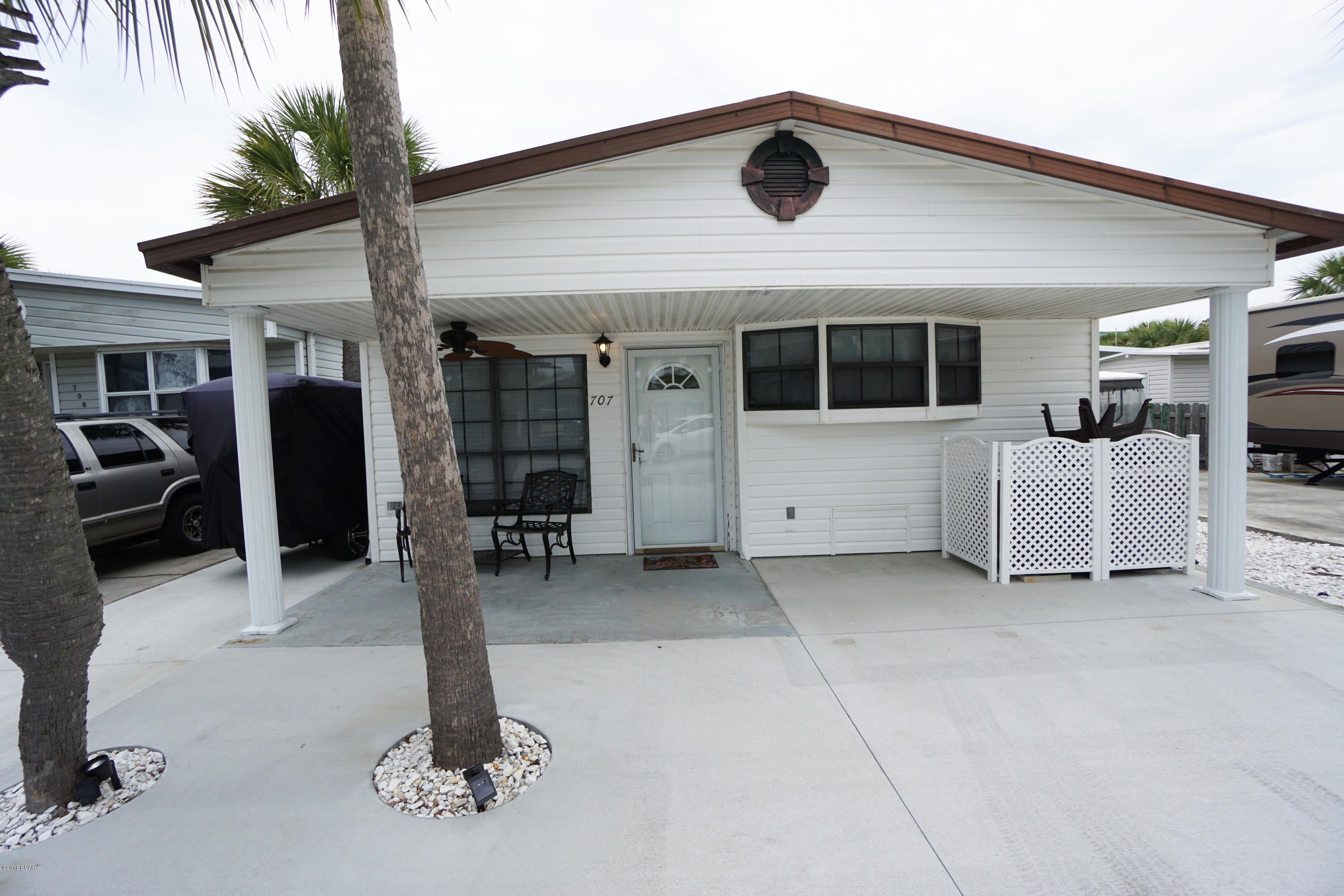 Wonderful open floor plan is what you will find here in this 2 bedroom 2 bath Venture Out home. This home has new flooring, new A/C, new patio and new paint! It would be a perfect second home or investment opportunity. Just bring your swimsuit and get ready to relax. Venture Out has 300' on the beautiful pristine beaches of the Gulf of Mexico and 1,000' on the Grand Lagoon. Venture Out has something for everyone!