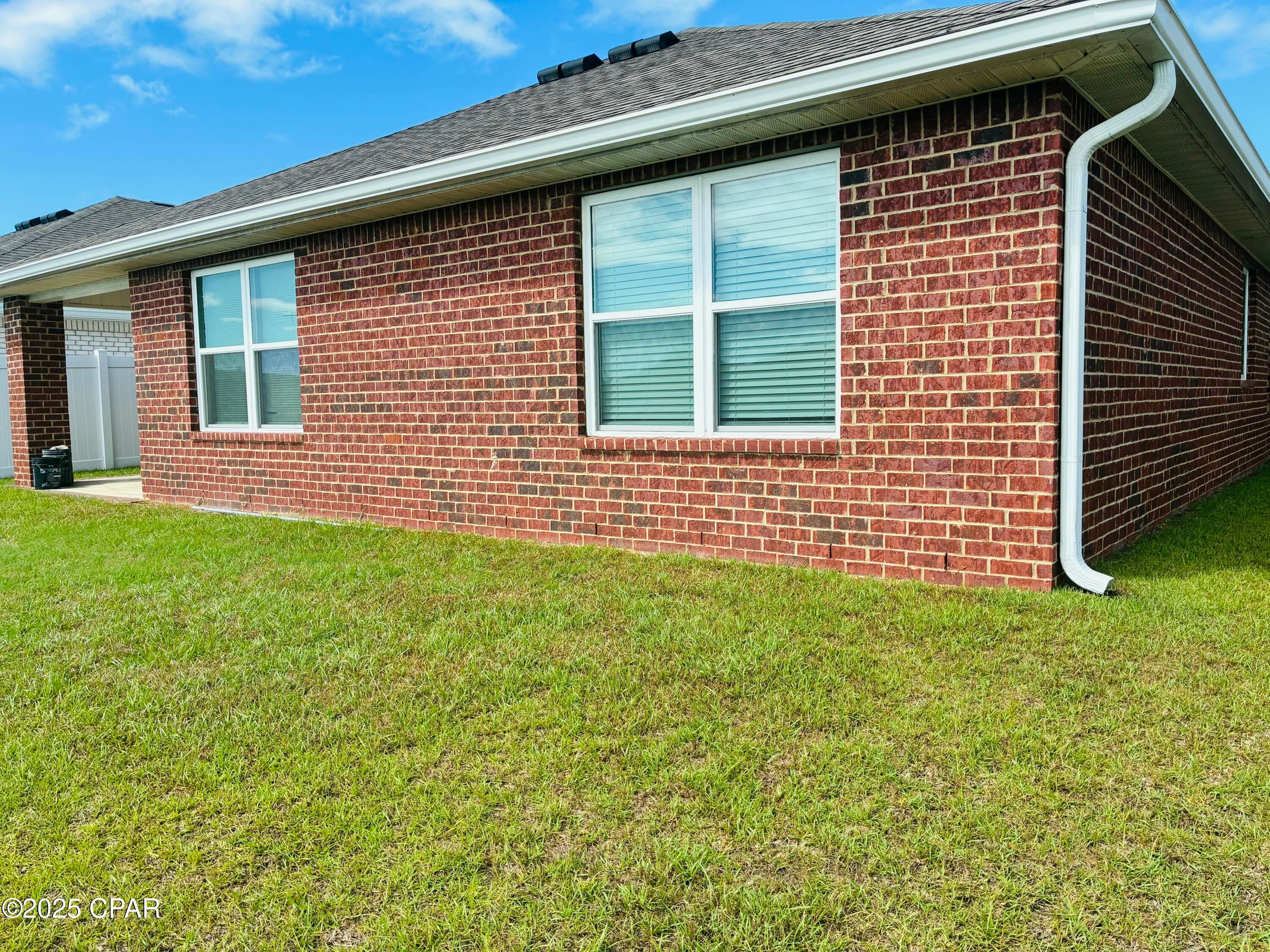 ''CURRENTLY UNDER CONTRACT, SELLER ACCEPTING BACKUP OFFERS''

Welcome to Liberty - Panama City's Premier Lifestyle Community!
Nestled off Star Avenue near Hwy 231, Liberty offers easy access to Tyndall Air Force Base (25 min), local hospitals (20 min), and top shopping and dining (under 15 min).

Enjoy resort-style living with a 7,500 sq. ft. community center featuring a full gym, wellness rooms, and a resort pool with splash pads, grilling stations, and plenty of outdoor seating. Scenic ponds, fountains, and walking trails add to the tranquil atmosphere.

This 4-bedroom, 2-bath Cali floorplan spans 1,830 sq. ft. with an open-concept design. The bright entryway leads to a spacious kitchen island overlooking the dining and living areas are perfect for entertaining. The primary suite offers a soaking tub, walk-in shower, and large closet. Luxury vinyl plank floors flow throughout the main areas, with plush carpet in the bedrooms. Home was built in 2022 but sold in 2023.

Situated on a beautiful lot backing to a peaceful pond and conservation area, this 4-sided brick home includes full sod coverage on all sides--ready for you to call home!