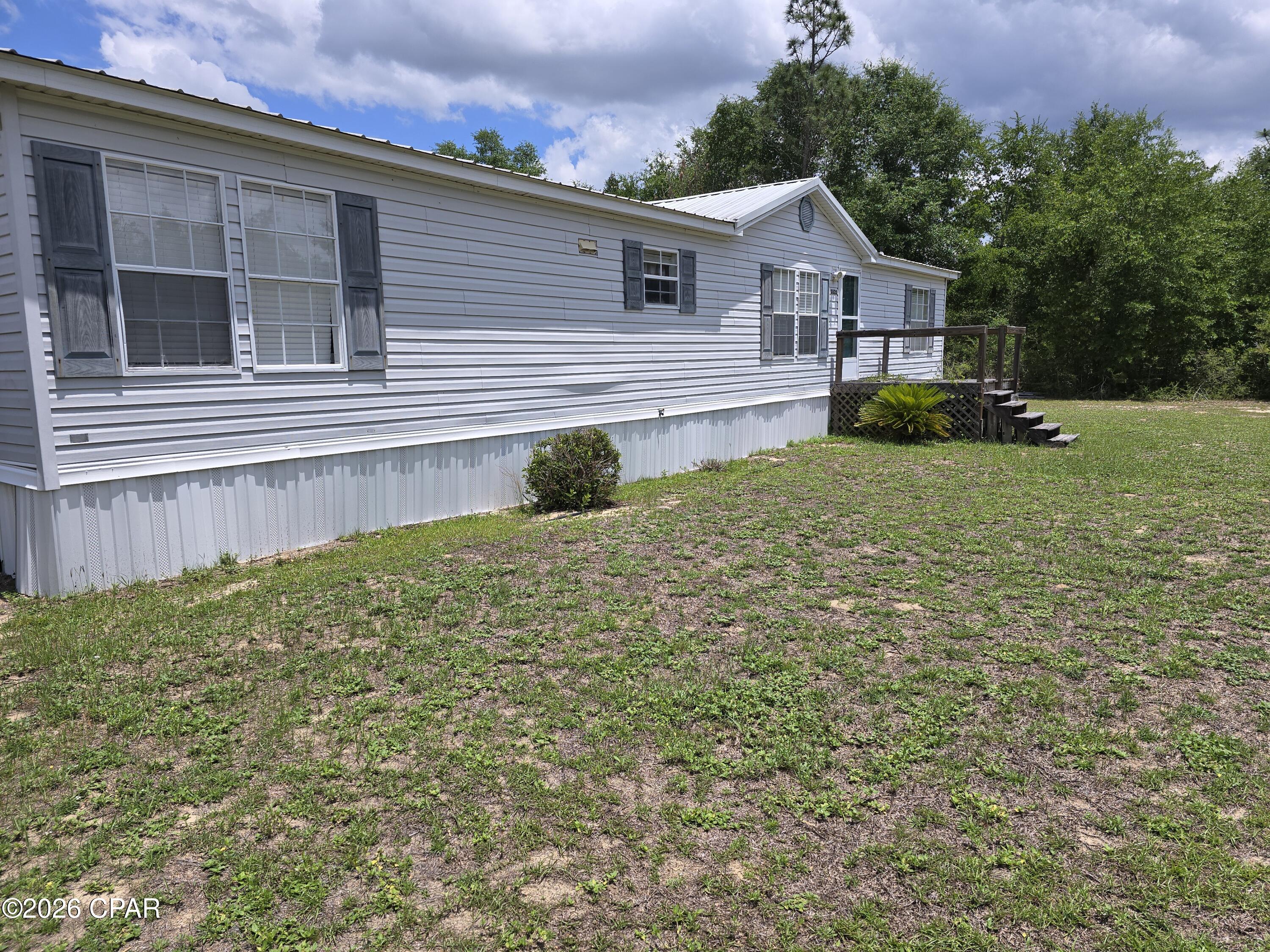 **Multiple Offers Exists/ Please submit your Highest and Best Offers before 1PM CST on Tuesday July 21st.** 

Nearly an acre of fenced land and a three-bedroom manufactured home -- that's the kind of combination that makes investors and bargain hunters sit up and pay attention. Tucked along Thomas Lane in quiet Fountain, Florida, this property delivers raw potential at a price point that leaves serious room to dream big.

The home features an open floor plan connecting the living, dining, and kitchen areas into one generous shared space. Three bedrooms and two full bathrooms round out the interior, giving you a functional layout that works well as-is or serves as the foundation for a complete transformation. Whether you're envisioning cosmetic updates or a full-scale renovation, the open configuration gives you creative freedom to shape this home into something uniquely yours.

Outside, the real magic reveals itself. Almost a full acre of fenced property stretches out around you, offering the kind of elbow room that's increasingly hard to find at this price. A detached carport keeps your vehicles sheltered from the elements, while a separate shed provides dedicated storage for tools, equipment, or weekend project supplies. There's space here to add workshops, gardens, or whatever your imagination conjures up.

Fountain offers peaceful country living without total isolation. Waller Elementary School is located in the area, and Panama City is a manageable drive west for shopping, dining, and healthcare. Northwest Florida Beaches International Airport connects you to destinations beyond the Panhandle whenever wanderlust strikes.

Affordable property with acreage and upside doesn't come around often -- schedule your visit today.