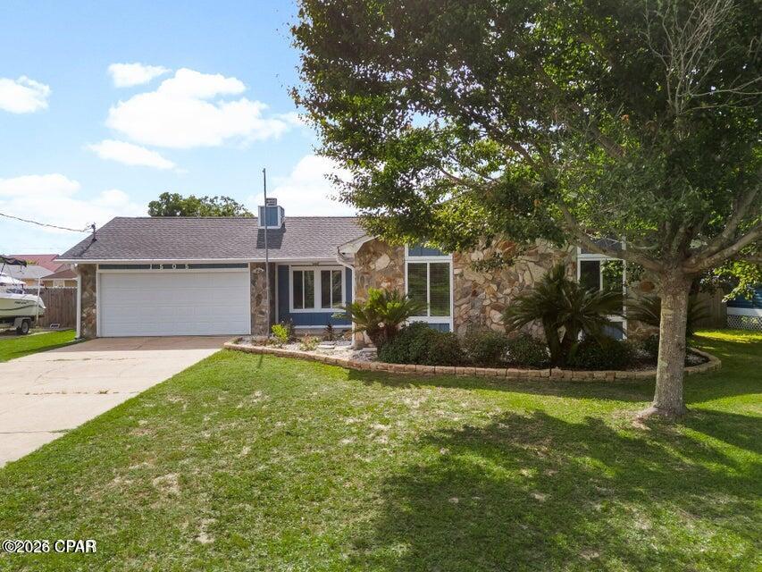 Great location for this well maintained home with NO HOA!  This home features 4 bedrooms and 2 baths! Plenty of room to spread out! The living room boasts a beautiful stone fireplace for chilly nights. Open floorplan flows into the airy dining room and kitchen which features granite countertops and breakfast bar. Lots of pantry space and updated appliances! The split floorplan highlights the Master bedroom off the dining room with a walk in closet and bathroom with walk in shower and double sinks. It also has doors leading out to the large screened in porch. The other 3 bedrooms are also spacious with an additional full bath on the other side of the house. Floors are all LVP. No carpet here! The backyard is privacy fenced with 2 storage buildings, a greenhouse, garden area and a chicken coop! There is a 2 car garage , washer dryer hookups (inside or in garage) and pantry leading to kitchen. All of this and so close to the water and Tyndall! Home has Hardy Board siding and new gutters. Also featured are the Solar Panels for extra low electric bills! Make an appt to see this one today!