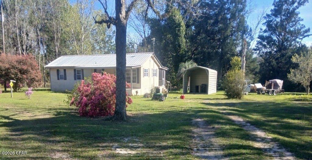 Nestled on 10 acres of beautiful wooded land in the peaceful countryside of DeFuniak Springs, this charming 3-bedroom, 2-bath home offers the perfect blend of privacy and comfort. Step inside to a large open kitchen featuring ample cabinet and counter space, plus a convenient breakfast bar overlooking the spacious family room. The home features tile and carpet flooring throughout, providing both durability and comfort. Enjoy quiet mornings on the covered front porch or unwind in the evenings on the screened back porch, surrounded by the natural beauty of your wooded acreage. Outside, the property includes a barn, offering excellent space for storage, hobbies, livestock, or equipment. With plenty of room to roam, garden, or create your own private retreat, this property captures the essence of country living while still being within reach of town amenities. A rare opportunity to own acreage in the scenic surroundings of Historic DeFuniak Springs--schedule your showing today! All information recorded in the MLS is intended to be accurate but cannot be guaranteed, buyer advised to verify. Sold As-Is