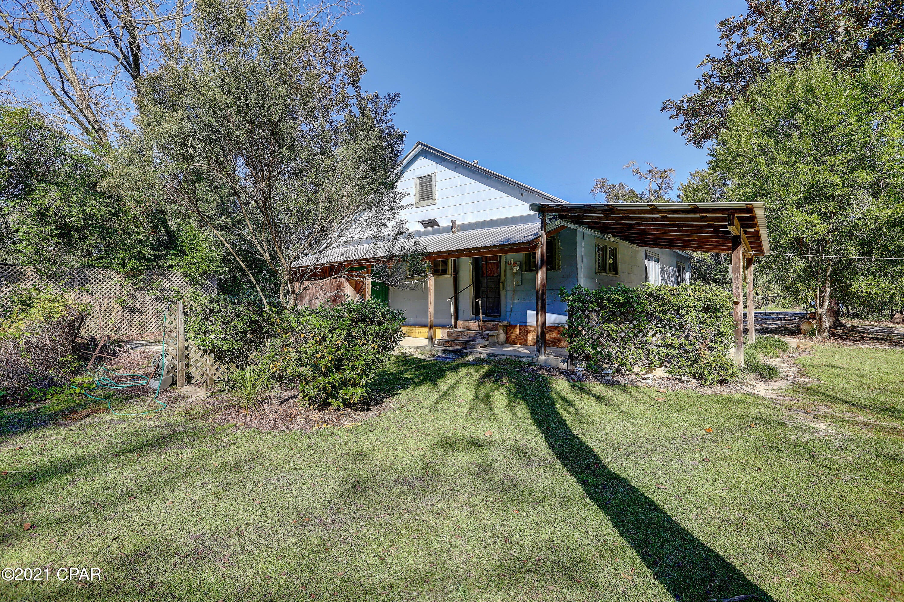 This home is located within the city limits of Vernon on a large well maintained fenced in lot.  There is a large front porch & as you enter through the front door there is a living area & a large master bedroom to the right with a non working fireplace.  The dining area/second living space is located right off the kitchen & the laundry is by the bathroom.  This home offers two generous sized bedrooms & one smaller bedroom, each with it's own closet. The yard is accompanied by a large workshop, perfect for storing tools & equipment.  The home & property are wired for ADT security, electrical panel was updated in 2014, tin roof was put on over existing shingle roof in 2013, and water heater replaced in 2014. In the backyard you will find a fig tree & two generous size scuppernong vines & the yard is adorned with azaleas & other flower blooming trees & bushes. The yard is fenced in & a great area to allow the children to play. The original wood slat boards are hidden behind the walls & the ceilings are bead board. This home offers character & charm throughout & with the right owner, could be transformed into a lovely home.