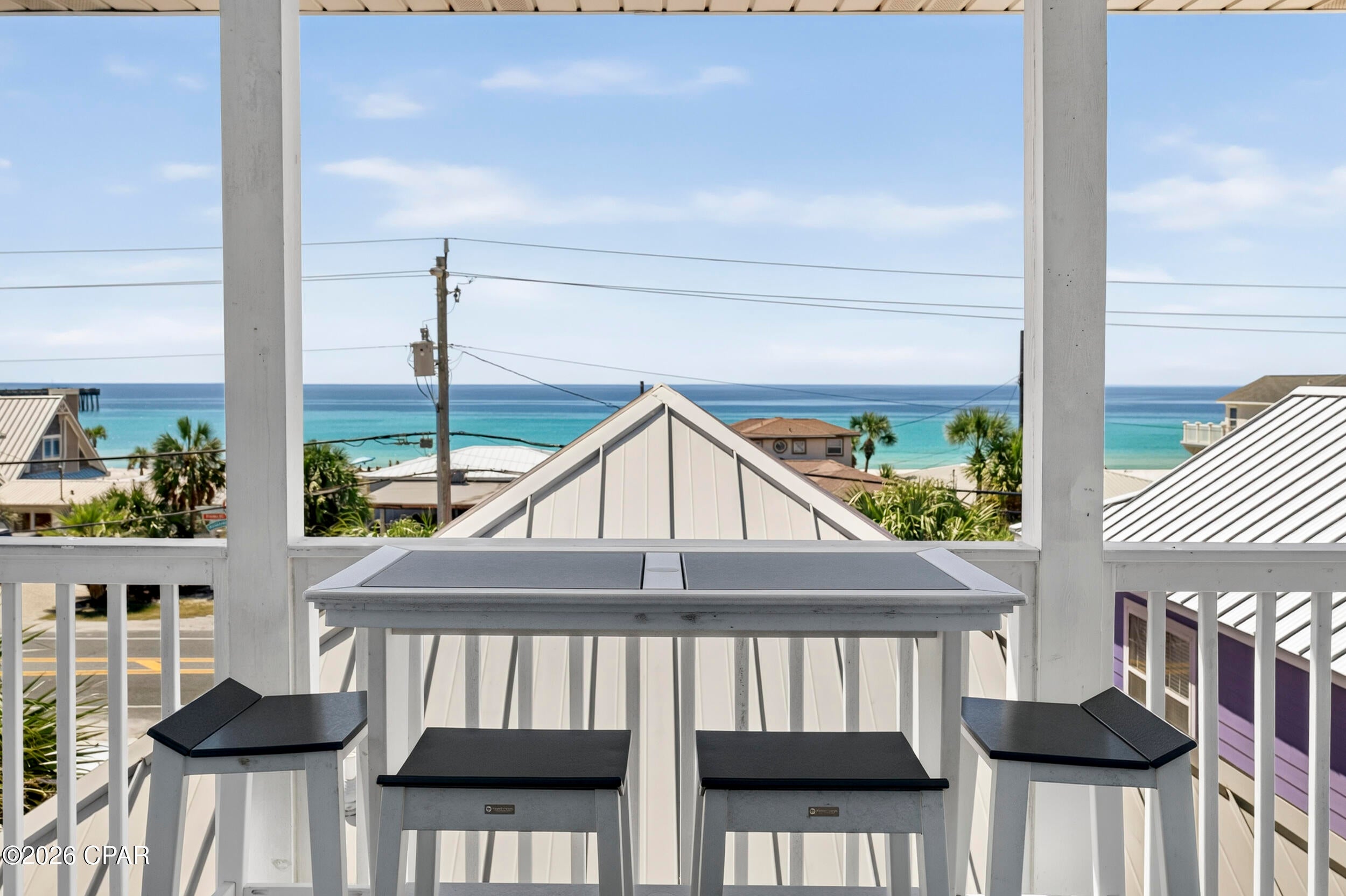 Beach days, sunset walks and dinner out can all be part of the routine at Pier Haven, a three-story cottage in Summer Towne Cottages, a colorful, low-density beach community just steps from the Gulf on Front Beach Road in Panama City Beach. With the beach, Pier Park, Russell-Fields Pier, shopping, restaurants and entertainment all within easy walking distance, the location makes it easy to leave the car behind and settle into the best parts of beach life.  Pier Haven is the cottage closest to Pier Park, putting some of the area's most popular spots practically at your doorstep.

Short-term rentals are allowed, and Pier Haven has an established rental history, generating the equivalent of $93,089 in 2023, $93,615 in 2024 and $90,643 in 2025 (including owner usage). For a buyer looking for a Panama City Beach vacation home that can also generate rental income when not being enjoyed personally, the combination of location, layout and established rental performance is compelling.

Summer Towne Cottages offers a different kind of beach getaway - a collection of cottage-style homes gathered around a seasonal community pool rather than a large resort tower. There are no crowded lobbies or elevators to navigate, and this home comes with its own two-car garage. Guests can also enjoy the community's sun deck, seasonal outdoor pool, BBQ facilities and picnic area.

Inside, the three-story layout gives everyone room to spread out while creating distinct spaces for gathering and relaxing. The main living area occupies the top floor, where vaulted ceilings, tile flooring and an open floor plan make the space feel bright and airy. A covered porch with grill extends the living area outdoors, while the top deck offers impressive beach views and the kind of gulf breeze that makes you want to stay outside a little longer.

The top-floor primary suite has its own reading nook, private bath and balcony overlooking the beach, creating a private retreat with a front-row beach view. Two additional bedroom suites are located on the second floor, each with a private bathroom. One includes a twin trundle bed tucked into a cozy nook, while the other features a queen bed and a private balcony overlooking the community pool. The washer and dryer are conveniently located on this level.

The first floor adds another bedroom with a twin-over-full trundle bed, along with a private bathroom and foyer entrance. With three bedrooms, three full baths and a half bath, the layout gives families and groups plenty of room to spread out, while the multiple bedrooms, private baths and outdoor spaces make the home especially well suited to vacation stays.

Pier Haven offers a distinctly different way to experience Panama City Beach: your own colorful cottage by the Gulf, with the beach and the best of the west end just outside the door. Schedule a tour to take a closer look at Pier Haven and see what makes this location so easy to enjoy.