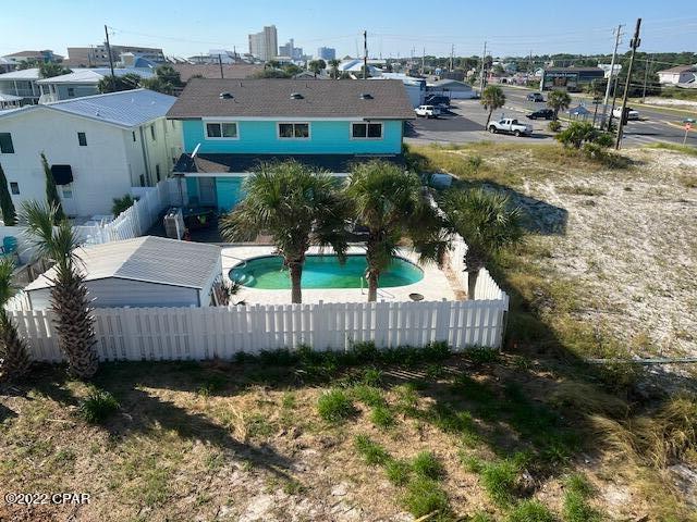 This is a rare find on the east side of Panama City Beach.  Three attached townhomes with 2 bedrooms 2 baths each, single car carport for each unit, new windows, sheetrock, glass doors, and roof.  The property had some damages from Hurricane Michael.  Most things have been fixed except cosmetics.  Shared pool in the back with nice deck for entertaining. Approximately 1 block from Beach Access 17.  Perfect for an investor!  More photos to come!
