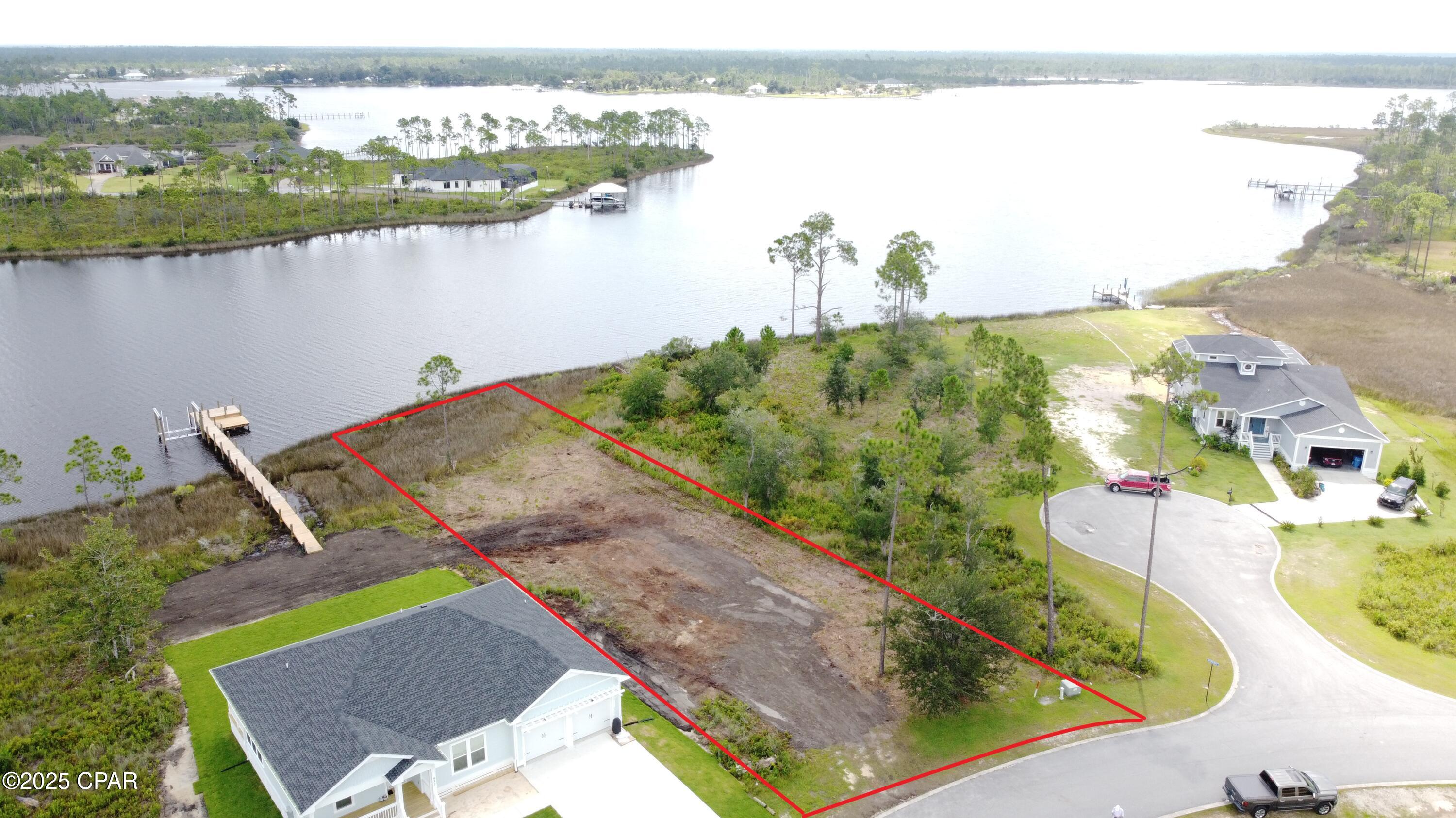 Deepwater dock-able waterfront in the gated Laird Point Community. Nearly half an acre with 75 feet on the water. Beautiful water views.  The seller has House plans that have already been approved by the HOA and will provide the full set of plans to new buyer. The dock has already been approved and permitted by the FDEP. Boundary survey, topographic and elevation survey already complete. 75 feet on the water and excellent year-round water depths. Will easily accommodate your large cruiser or fishing boat. No worries of low tides or low bridges preventing your short boat ride to the Gulf. Only a short dock is needed for great access. Laird Point is located on East Bay which boasts some of the best redfish and speckled trout fishing in the panhandle. This gated waterfront community offers city utilities, underground electric, and ribbon curbed streets. Amenities include tennis courts, new pickleball courts, and RV/Boat storage. Experience water views at nearly every turn in this community. Great proximity to Mexico Beach, Port St Joe and Panama City Beach. Close to shopping and restaurants. Call to schedule a tour of Laird Point.