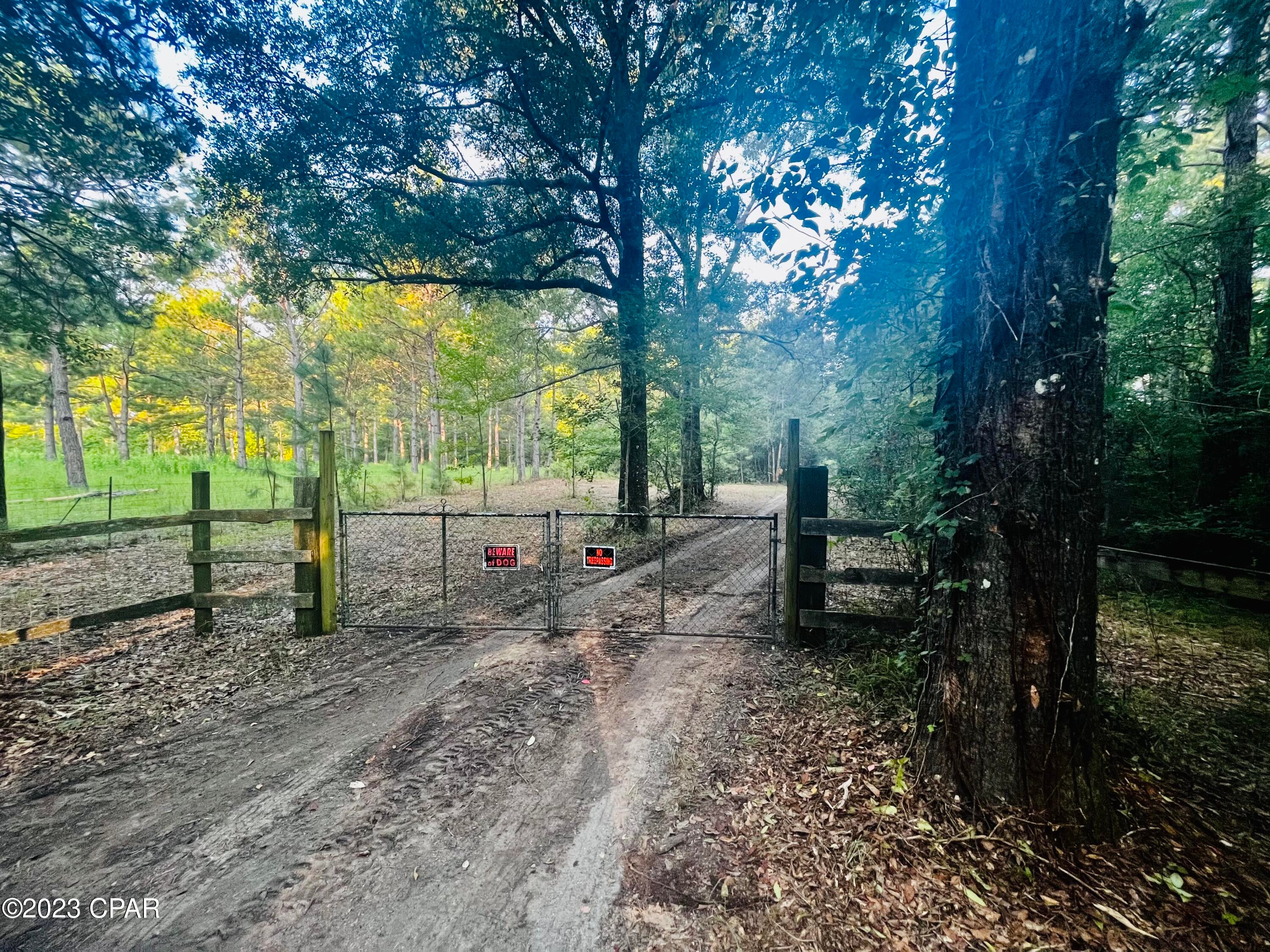 Welcome to your very own hidden gem in Vernon, FL! Follow the long driveway back to a secluded paradise.  This wooded parcel offers a breathtaking escape from the hustle and bustle of everyday life. Nature enthusiasts, hunters and adventurers alike will find enjoyment in this peaceful setting. Surrounded by lush greenery and bordered by a gentle stream, you'll find yourself immersed in the beauty of nature.  

The centerpiece of the property is a unique arrangement of portable buildings that have been thoughtfully connected to create a versatile space. This setup allows for various possibilities, making it ideal for use as a temporary residence, a recreational getaway, a cozy hunting cabin, or simply as extra storage for your outdoor equipment and belongings.  The property also includes a pole barn, ideal for storing outdoor gear, recreational equipment, or any essentials you may need for your adventures.

For those who love water-based adventures, Culpepper Landing is a mere stones throw away.  It offers a public boat launch to the beautiful waters of Holmes Creek, where you can indulge in boating or fishing. 

Situated just a short distance from the small town of Vernon, you have the perfect balance of seclusion and accessibility. Explore the local shops, meet friendly neighbors, and experience the warm community spirit.

If you've been yearning for a relaxing retreat, seize this rare opportunity to own your slice of paradise today!
