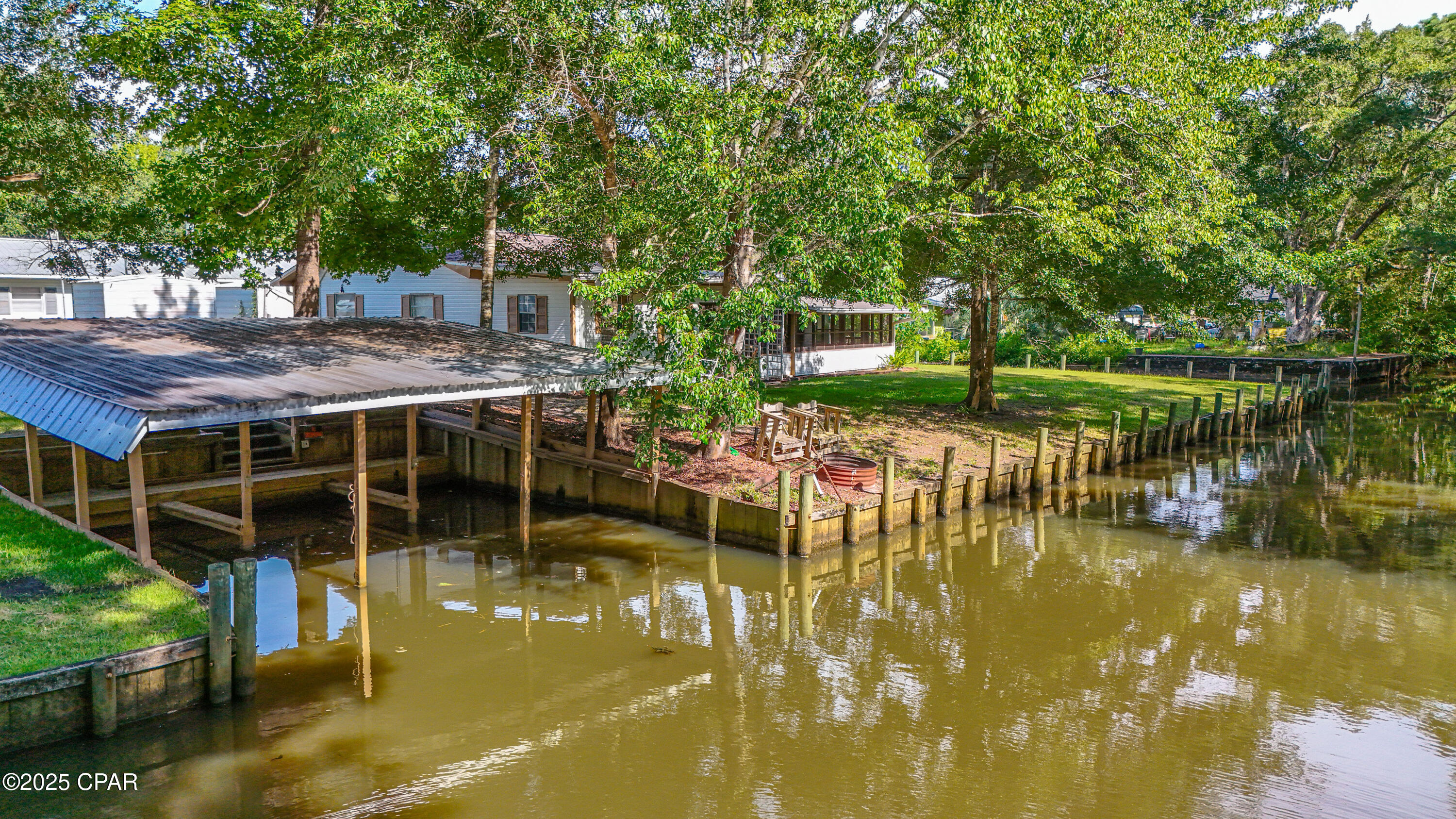 AMAZING OPPORTUNITY!!!  Waterfront Living at Its Finest - Welcome to Bunker Creek Bliss! Tucked into the scenic charm of Bunker Creek, this captivating Southern, river camp-style retreat offers everything your boating, fishing, and relaxing heart desires! Surrounded on two sides by 125 feet of prime waterfront along a 20' wide, 4' deep canal (even at low tide!), this .21-acre gem is your front-row seat to the wild beauty of the Choctawhatchee River Basin.
Inside, you'll find a bright and airy 2-bedroom, 2-bath plan with a fabulous kitchen, bonus room with a fireplace and a great screened porch for entertaining, grilling, or soaking up sunsets.  Live here peacefully or escape to your own personal retreat where comfort and convenience meets coastal charm!
But the magic doesn't stop there... Outside, you'll discover:
Three covered boat slips, and a sea wall for seamless days on the water
A screened patio that is perfect for kicking back and relaxing.
Only minutes to Choctawhatchee Bay, the intracoastal, and iconic spots like Crab Island--this is more than a home, it's a lifestyle.  The river and the bay are calling you home!!