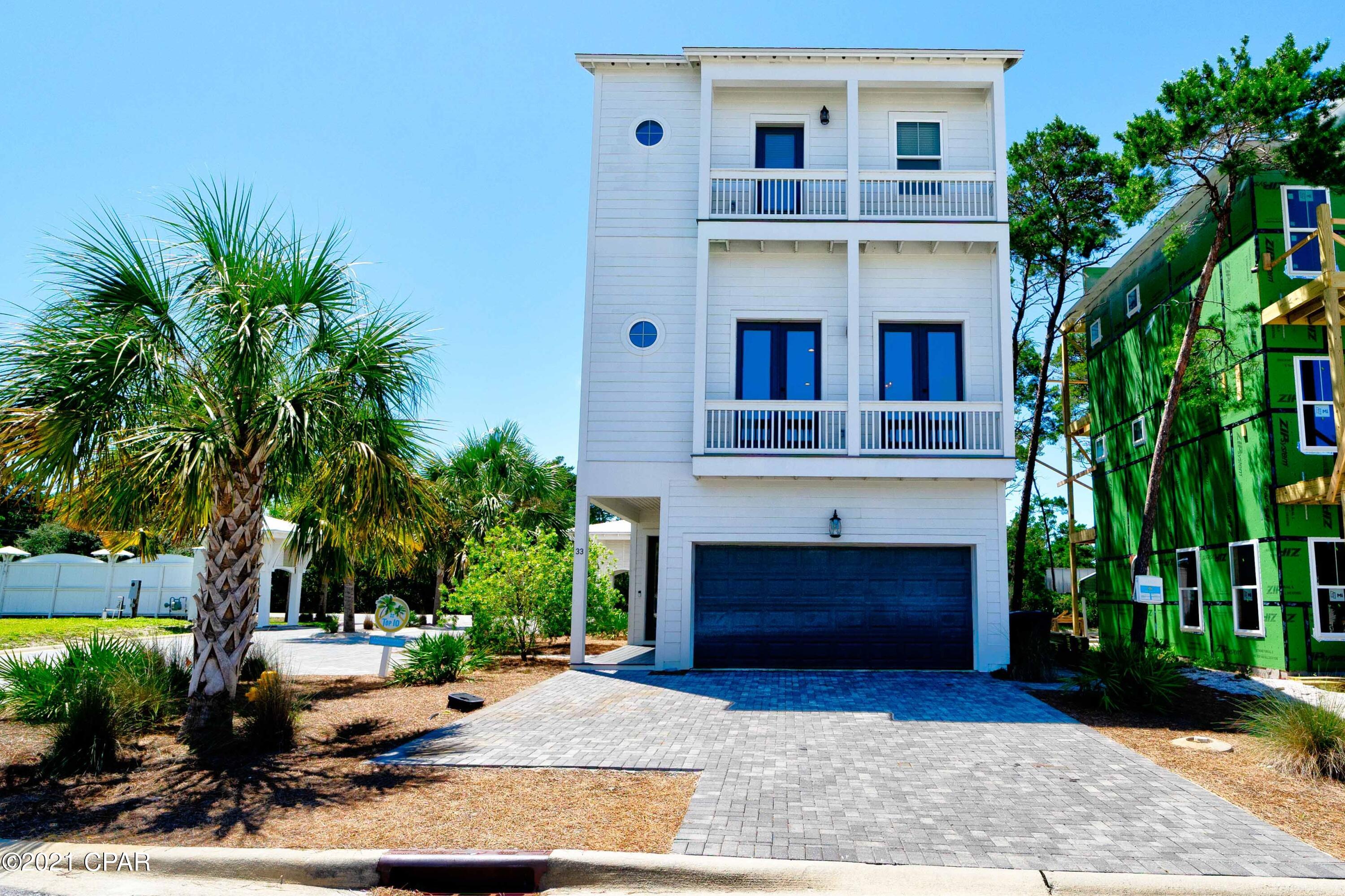 Welcome to Endless Summer, a beautifully furnished beach retreat that is move in ready and located in a highly desirable neighborhood in Inlet Beach. The Ivy at Inlet Beach is a private, rental friendly community that's within close proximity to fine dining, shopping, Scenic 30A, Panama City Beach, and it's within a ½ mile to public beach access and the Gulf of Mexico. This 4-bedroom, 3.5 bath house is perfect for beach living, enjoying family time or entertaining with its ample outdoor living space provided by the two large deck areas on the back of the house and the bright open floorplan. Upgrades include 10- and 12-foot ceilings on the first and second floors, gourmet kitchen with large island, quartz countertops, stainless appliances, vented hood and large gas cooktop stove, Cont... shiplap accents, rainfall shower in the master, ductless AC units with separate controls in each room, tankless hot water heater, airconditioned and improved 2 car garage, outdoor shower, paver driveway and more!  Upon entering the home, the first floor has 2 bedrooms with a Jack and Jill bathroom, owners' closet and a two-car garage that has its own AC. The garage area with its TV and furnishings can be used for entertaining or parking vehicles if needed. Also, in the garage area is a separate room for storing your beach supplies, with a door leading to the outside shower area. The second floor is the main living area which has an open floorplan. It includes a kitchen that opens to the large living room and combined dining area. Also located on the second floor is a large outdoor living area at the back of the home, a balcony at the front of the home, and a half bath that's tucked away by the stairwell. The master is located on the third level and has access to the second balcony. The master bath offers dual vanities, a stand-alone shower, and a walk-in closet. An additional guest bedroom, full bathroom, walk in laundry room and a second outside living area complete the third floor. This property is located on a corner lot and will be across from the community pool once it's built. The property is being sold fully furnished and come with 5 ½ months of rental history. Whether you decide to use the home as a permanent residence, secondary residence, or a rental investment, this home has endless potential! Call for a showing today - you do not want to miss out on the opportunity to own this beach house!