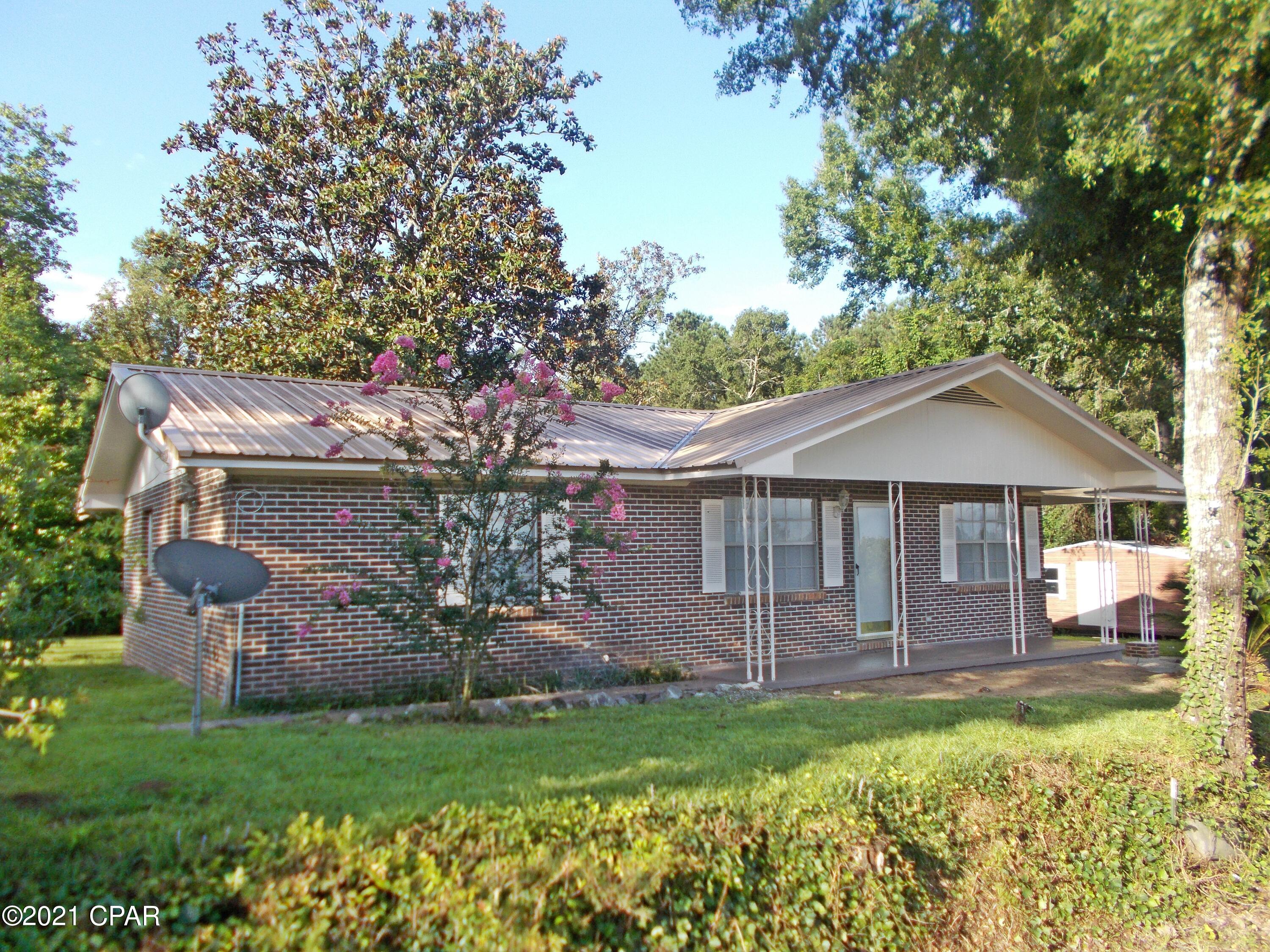 This home was updated 3 years ago including a new AC unit, and used as  a rental there has been additional work on it to list it. new paint, new laminate floors in bedrooms new ceiling fans new blinds, some new  interior doors new paint outside, new ceiling fans, it is on a quiet country road not far from Graceville or Dothan, nice large shed in back, level lot, it also has a metal roof, call to view it today it is vacant and easy to show.