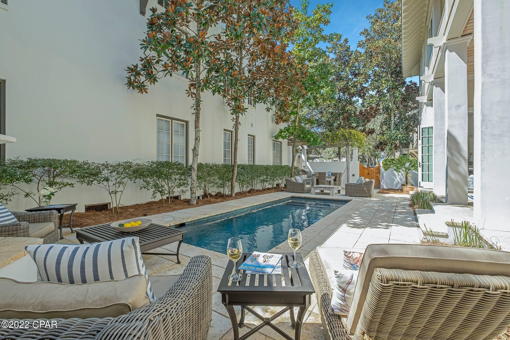 Step into one of Rosemary's largest outdoor yard living spaces, a serene sanctuary. Located on the coveted side of 30a with easy beach access. This Rosemary Beach home with a pool and carriage house is designed to entertain. The living, dining and outdoor porch includes two fireplaces and eating areas that flow as one gracious space. Soft palettes of blues, greens, and sand colored décor by Pizitz of Seaside. Craftsmanship abounds with old Florida pecky cypress beams and 100 year sinker cypress custom cabinets, as well as all new white oak beach washed flooring. The home has been completely remodeled and features beautifully tiled bathrooms and new cabinetry. Start with a perfect kitchen inside where the meal completes with outdoor grilling under the vine covered pergola. Such a heavenly house for kid's play with two upstairs porches for painting, napping and reading when not swimming in the heated and lighted pool. Both the young and adult kids will love to take a private night swim and make smores in the wood fireplace. The outdoor sound speakers (grandfathered in by RB) adds the perfect ambiance for memorable gatherings day or night. This "Casa Spiaggia" is ready for a new family to unpack their bags and settle into the simple art of living at the beach. Located in close proximity to the Town Square, all of your dining and shopping needs are just a short walk. This home is professionally decorated with custom furniture living room pieces, and the home was decorated by Pizitz, Seaside. The property is Artfully managed by 30A Luxury Vacations - 2021 Net Annual Income for main and carriage house: $220,000, which was only for 16 weeks due to many owner days taken up. This property will perform extremely lucrative on a rental program. Don't miss out on this opportunity to purchase one of the only well priced available homes in Rosemary Beach on the South Side. You won't want to miss out on viewing this exquisite home!
