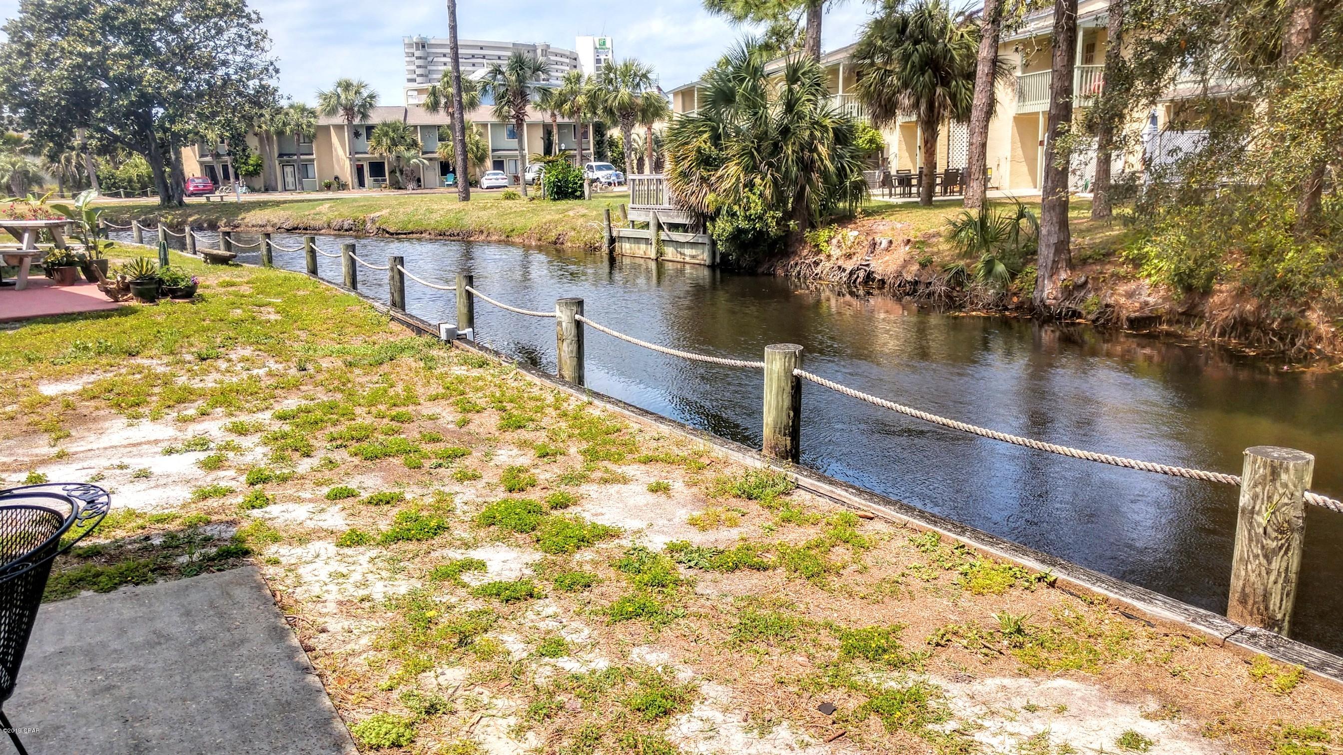 ''Island Unit'' + ''End Unit'' + ''On the CANAL''  very nice 2 Bedroom Townhouse with 2.5 Baths located in a Gated Resort. If you are looking for a ''Beach House'' in a Resort that is WALKING Distance to the BEACH... Here it is! The HOA Dues are only $450 a Quarter NOT a Month and that pays for your  Basic Cable Package, Termite Bond, Household Trash, some Pest Control, Mowing your Lawn, and Lots of Amenities. Speaking of Amenities, there are 11 Pools ''5 Heated'', Shuffleboard Courts, Tennis Courts ''2 Lighted'', an 18 hole Mini Golf Course, Conference Center, Fitness Room PLUS there is a Private Clubhouse with a Snackbar and a Pool directly on the Beach and it also ''Gated''!!! There is NO Extra Charge to use the amenities.  Age, SF, and Dimensions are approximate... please verify if imp