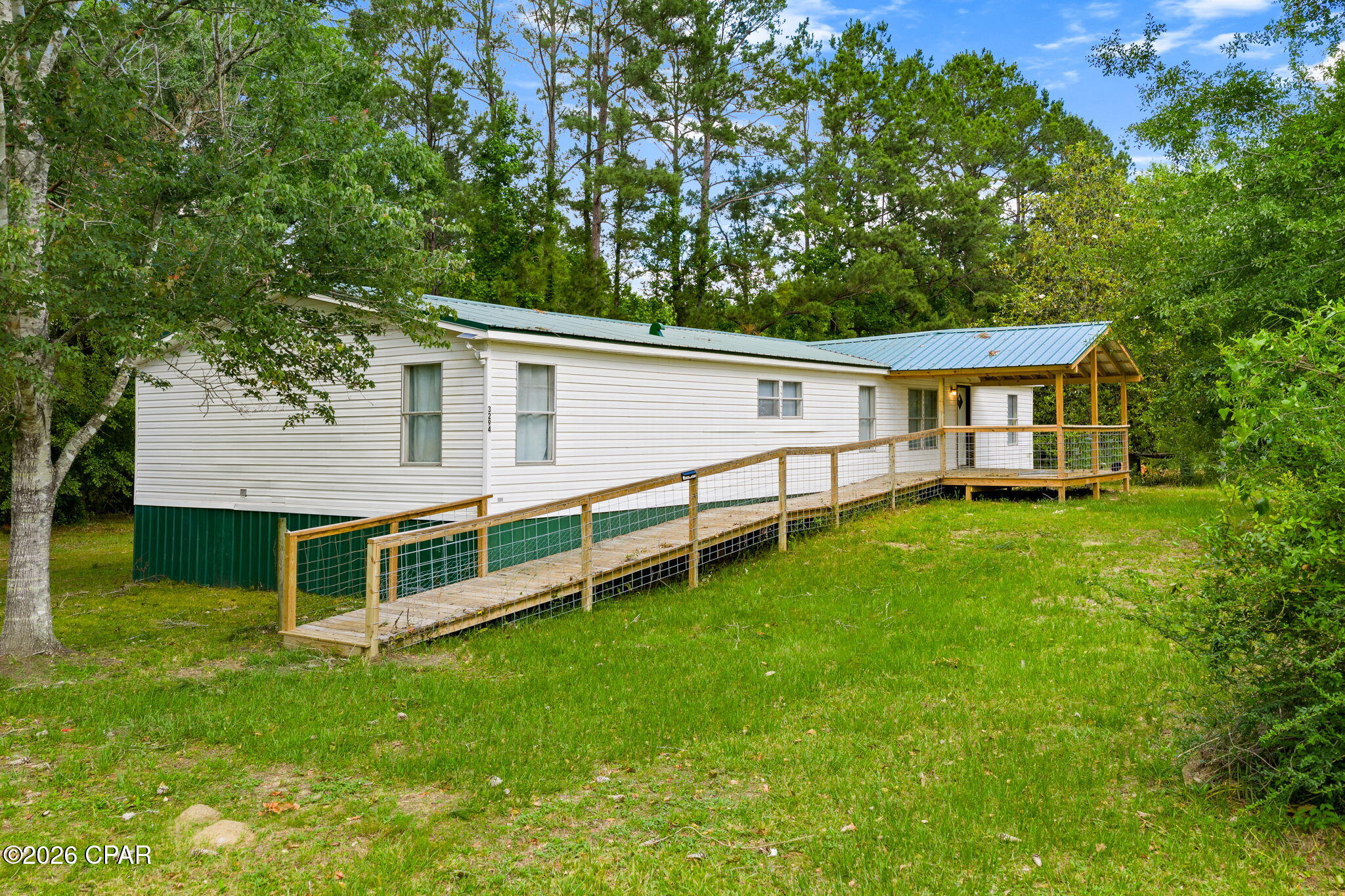 Tucked away in the peaceful town of Vernon, this spacious 4-bedroom, 2-bath home offers over 2,000 square feet of comfortable living space in a beautiful rural setting just minutes from some of Northwest Florida's most sought-after natural springs.

Inside, the home features a large open living area, a generous kitchen with ample cabinetry and space for an island, and a flexible split-bedroom layout designed for everyday comfort. The oversized primary suite includes a beautifully tiled walk-in shower along with an attached bonus space that would make an ideal home office, library, hobby room, dressing area, fitness space, or future custom closet expansion.

Recent updates throughout the home, including a newer metal roof, provide a clean, move-in-ready feel with modern touches and spacious rooms throughout. Covered porches on both the front and back of the home add to the charm and create inviting spaces to relax and enjoy the surrounding natural setting. Select furnishings may be negotiable with an acceptable offer.

Looking for an investment opportunity? Located next door to Cypress Springs Canoe Adventures and less than a 1 mile kayak paddle to the springs themselves, this property places outdoor recreation right at your doorstep. AirBnB the home to capture those visiting the springs!

Enjoy convenient access to kayaking, canoeing, spring-fed waters, and the natural beauty that makes Washington County such a special part of the Florida Panhandle. A volunteer fire station is also located less than 2 miles away, and buyers are encouraged to verify any potential insurance credits related to proximity to fire services.

If you've been searching for space, flexibility, and a quieter pace of life without sacrificing access to outdoor adventure, this Vernon property is one worth seeing in person. Closing Cost Assistance may be available as well!