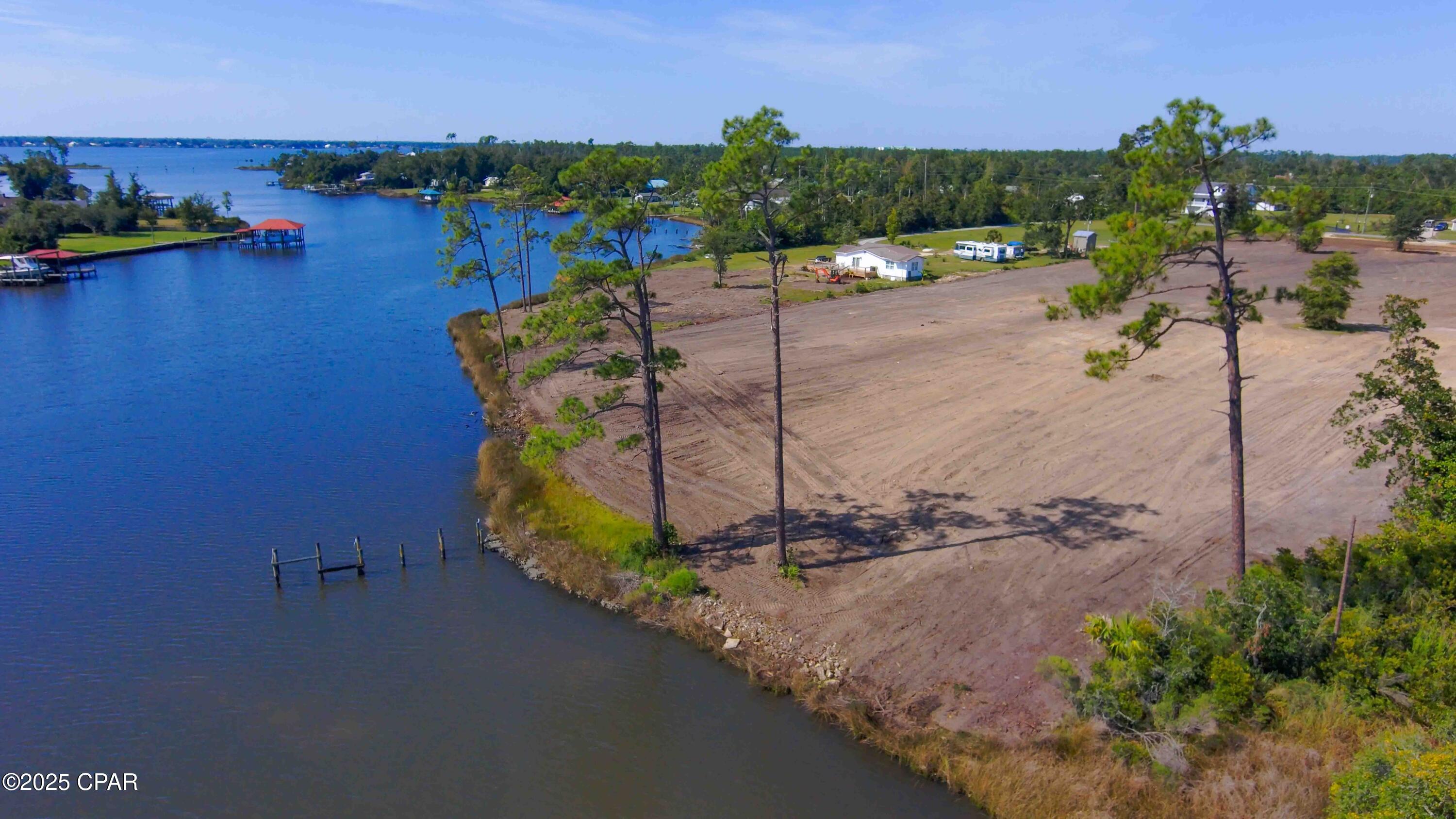 JUST REDUCED to SELL GULF ACCESS Deep Water to build your Waterfront Home on in Fast Growing Southport FL! Only 5 minutes from Lynn Haven.
Rare chance to own a 1.55-acre waterfront parcel just on the other side of Lynn Haven and less than 20 minutes to the Beaches Intl Airport . Lot is located on Bay Crest in Southport one of Bay County's fastest-growing areas. This property offers approximately 132.74 feet of waterfront along Gainer Bayou (per survey/legal description), over 800 ft deep giving you the space and setting to build a private waterfront home with a big building or, weekend escape, or investment hold in an area where waterfront land is getting harder to find.
Zoned R-2 Residential, this parcel allows a range of residential uses (buyer to verify intended use, density, and permitting). You'll love the flexibility here: no HOA, paved road access, nearby public utilities (water and electric available; septic required), and room for thoughtful design and outdoor living.
Even better, the adjacent 3.58-acre waterfront parcel is also available which can be split, giving buyers the option to combine both parcels for a 5.13-acre assemblage with approximately 350 feet of total waterfront or split to sell individually 
 Survey available.
Note: Lot boundaries are approximate and for visualization only. Buyer to verify all information deemed important, including zoning, utilities, waterfront measurements, flood zone