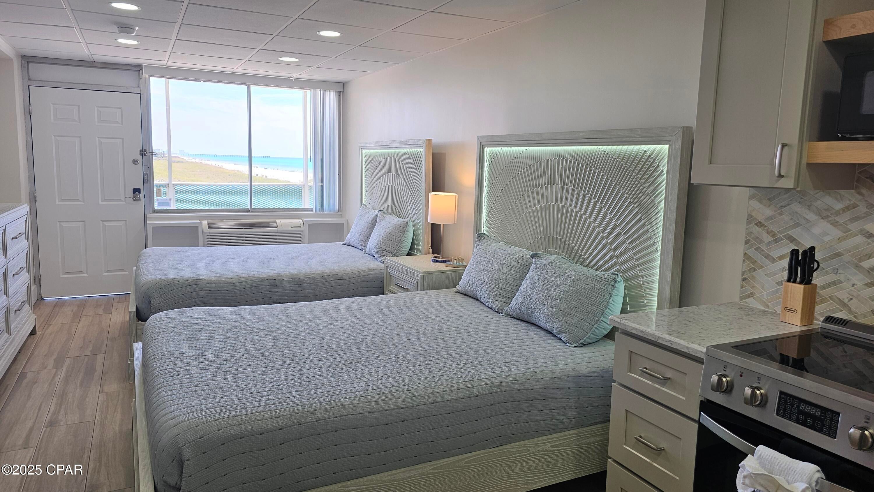 Wake up to the gentle rhythm of the waves and breathtaking views of the pristine Bid-A-Wee beach and the emerald coast. This stunning, completely renovated studio unit offers the perfect blend of modern luxury and coastal charm. Step inside to a beautifully designed space featuring elegant wood grain tile flooring that provides both style and durability. The kitchen is a true highlight, boasting sleek quartz countertops and a chic stone backsplash, perfect for preparing meals after a day in the sun. This fully furnished retreat is equipped with two comfortable queen beds, offering plenty of space for family or guests. Enjoy your morning coffee or evening cocktails while soaking in the panoramic gulf views right from your window. Make your offer today and start enjoying the emerald coast lifestyle you deserve!