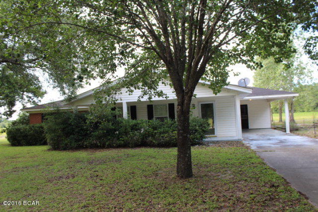 PRICE REDUCTION!! This is what you have been waiting for! A country home on almost 20 acres of land. Home is very spacious with a large living room, a kitchen with smooth surface stove, wall oven, a microwave and a breakfast bar. The utility room is equipped with washer and dryer. There is a covered carport between the main house and a 30x40 room with 1/2 bath, gas stove, sink and refrigerator. A great place for large cookouts, parties, entertaining or even utilize it as a hobby room; has endless uses. There is also a garage. The rear has place for storage for farm equipment, etc. There is a paved driveway from the street to the house. Use the wrought iron fenced courtyard for raised gardening, flower beds or as an outdoor sitting room! Make your appointment today to see this gem.