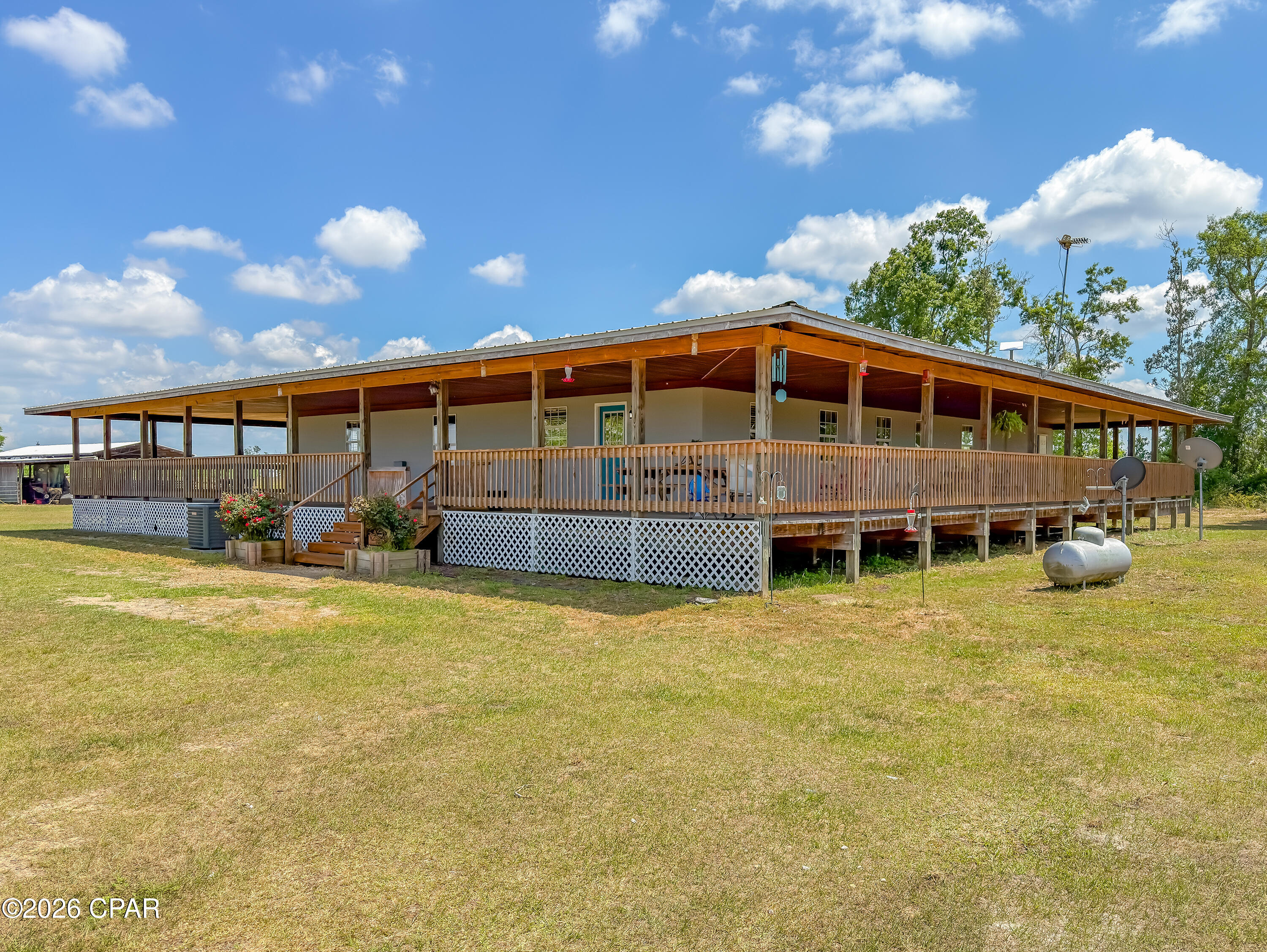 CURRENTLY UNDER CONTRACT, SELLER WILL CONSIDER BACKUP OFFERS

Welcome to 11842 SW State Road 73 in Clarksville, Florida, where space, comfort, and country living come together on 25.61 beautiful acres. If you've been looking for room to spread out, enjoy the outdoors, and create your own lifestyle, this property delivers.

Built in 2005, this 4-bedroom, 2-bath home offers 1,896 square feet of warm, inviting living space with natural wood finishes that create a cozy, cabin-style feel. The spacious living area is perfect for relaxing or gathering, while the kitchen offers plenty of cabinet space and a functional layout for everyday living. Just off the home, a wide 14-foot deck gives you the perfect place to enjoy your morning coffee or unwind in the evenings while taking in your surroundings. An 8x10 office provides a great space for working from home.

Attached to the home, you'll find a 25x13 bonus room with its own private access, ideal for a hobby space, game room, or flex area separated from the main home.

Step outside and enjoy everything this land has to offer, open pasture, a pond, and plenty of room for animals or recreation. The property features a barn with stalls, a smokehouse, and a large chicken coop, making it well suited for those wanting a more hands-on, outdoor lifestyle. The 55x30 metal workshop/shed with five roll-up bay doors offers excellent space for equipment, storage, or projects.

You'll also enjoy convenient access to the Florida Panhandle's best features, located about an hour from Panama City and Mexico Beach, giving you the option for easy coastal trips while still enjoying the space and privacy of country living.

An additional 15.53-acre adjoining parcel is also available (MLS 783445), offering even more opportunity.

If you're ready for space, privacy, and the chance to enjoy country living, schedule your showing soon and come experience it for yourself.