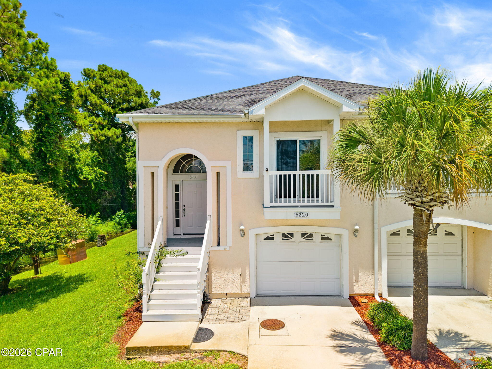 Welcome to this inviting two-story home in a prime North Lagoon Drive location, where coastal living meets everyday comfort. Set back on a beautifully landscaped lot with mature trees and strong curb appeal, this residence offers the perfect blend of comfort and cnvenience. You'll living just minutes from the beaches, restaurants, and attractions of Panama City Beach. 

The home features three spacious bedrooms and two full bathrooms. The generous master suite includes a large walk-in closet, private covered balcony access, and a luxurious master bath with a walk-in shower, separate jetted soaking tub, and double vanity. Downstairs you will find two additional bedrooms, a full bathroom, a large hall closet, and convenient garage access. One of the downstairs bedrooms opens directly onto the covered back porch and expansive backyard, creating a seamless connection to the outdoors. 

Upstairs, you'll love the open concept kitchen, dining and living area. The updated kitchen boasts matching GE appliances, updated cabinets and, a pantry, eat-in breakfast bar and abundant storage -- ideal for everyday meal prep and entertaining. Bright, open living spaces with tile flooring and high ceilings complete the comfortable and functional interior. Step outside from the living room to the front balcony, for a water view, overlooking North Lagoon. 

Outside, enjoy multiple outdoor living zones including the covered front balcony off the master, a spacious screened back porch, and a large grassy backyard perfect for gatherings, play, or future personalization. The two-car garage provides extra room for toys, beach gear, and additional storage under the stairs. 

This well-maintained home offers easy access to North Lagoon, quick drives to the Gulf, and the relaxed Florida lifestyle you've been looking for. Whether you're seeking a primary residence, vacation retreat, or investment property, 6220 North Lagoon Drive delivers comfort, updates, and location in one attractive package. Schedule your private showing today and imagine calling this slice of Panama City Beach home.
