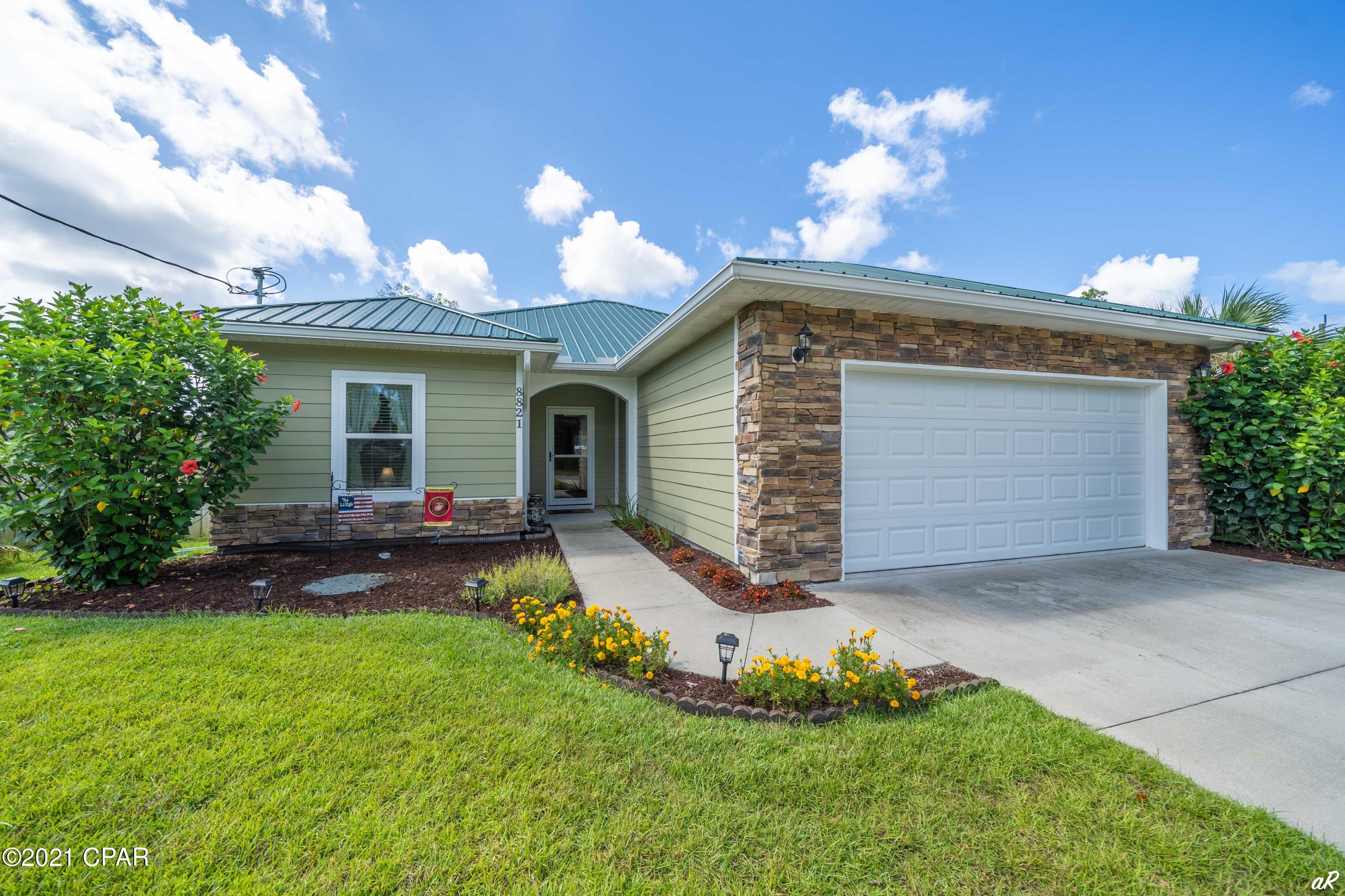 LIKE-NEW CONSTRUCTION BUILT IN 2016 LOCATED ONLY A MILE FROM THE BEACH! No HOA, plus short term rentals are allowed! Act fast and don't risk losing out on this beautiful, well-maintained home. Located close to local restaurants, stores, bars, and attractions on the east end of Panama City Beach. It's one of only a handful of listings currently priced under 350k on the beach. This home boasts granite kitchen and bathroom countertops, wood-look tile throughout the entire house with carpeted bedrooms, all stainless steel appliances, large master BR/BA with a walk-in closet, washer & dryer included, a covered and newly screened-in porch, a newly built entertainment patio perfect for grilling and entertaining guests, a new storm door and gutters, & nice 2-car garage. Must I say more? SHOW TODAY