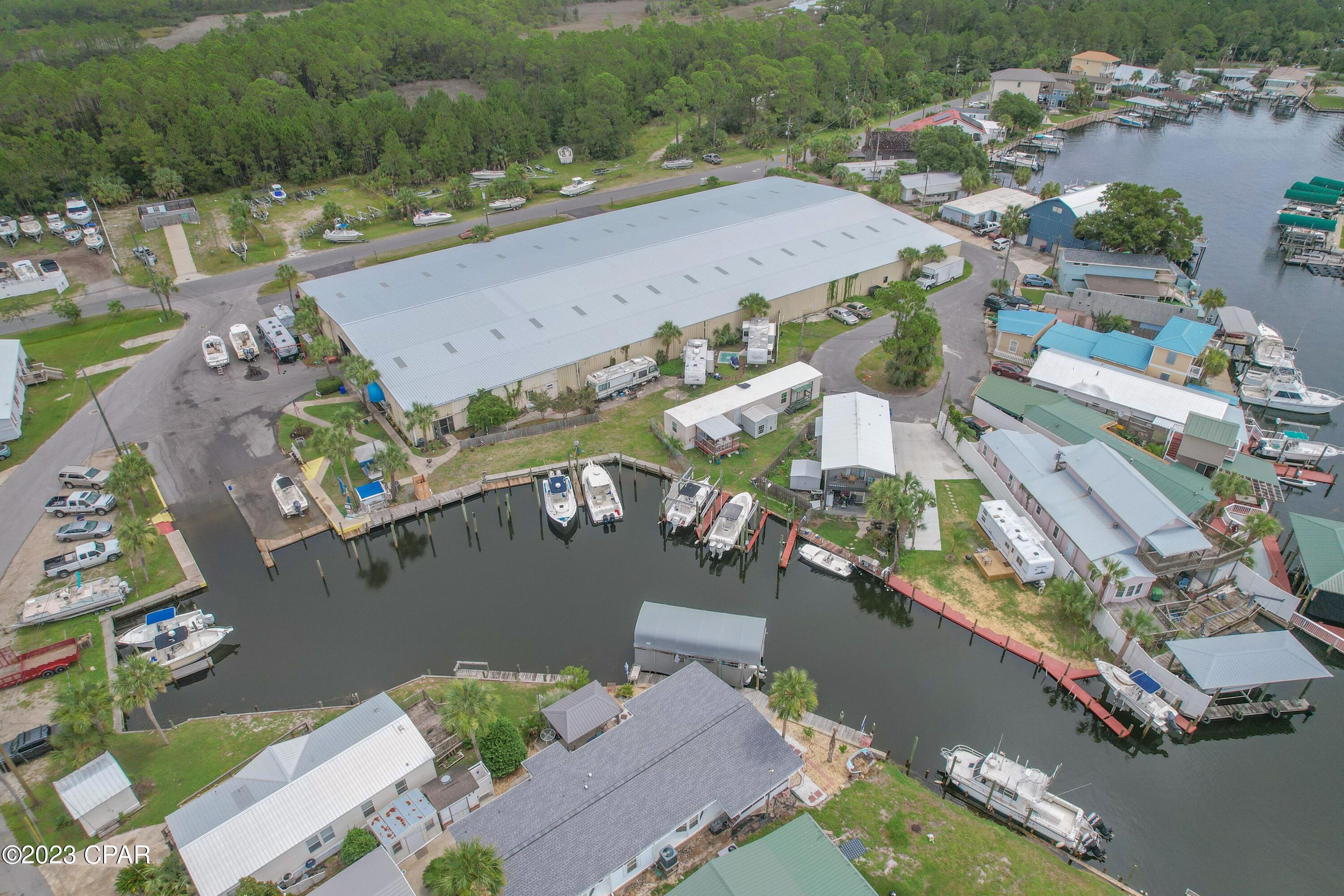 Bayside Marina is a full-service marina tucked away in the quiet corner of St Andrew Bay/Panama City Beach, and just 7 miles from the Gulf of Mexico, The Marina is in a protected deep-water Lagoon and straight access to the Gulf.  There are only 4 major marinas in the Panama City Beach area, and this is one of them and For Sale with Owner Financing if needed!  Marinas for sale are on high demand and rare to be on the market.  Marina incorporates a 45,000 square foot boat barn which can hold up to 105 boats as inside storage.  You have 240 feet of water frontage including 15 Wet Slips, and a fuel dock.  The outside dry storage across the street can hold up to 90 boats. This is a turnkey sale operation with 6 employees to include an On-Site Manager residing in the apartment.  Diversified revenue stream with sales up 23% this year. The Marina is 100% occupied and with a waiting list. There is a strong local and out of area demand for storage and service.  Seller is retiring and will entertain OWNER FINANCING WITH FLEXIBLE TERMS AND SUBSTANTIAL DOWN PAYMENT.