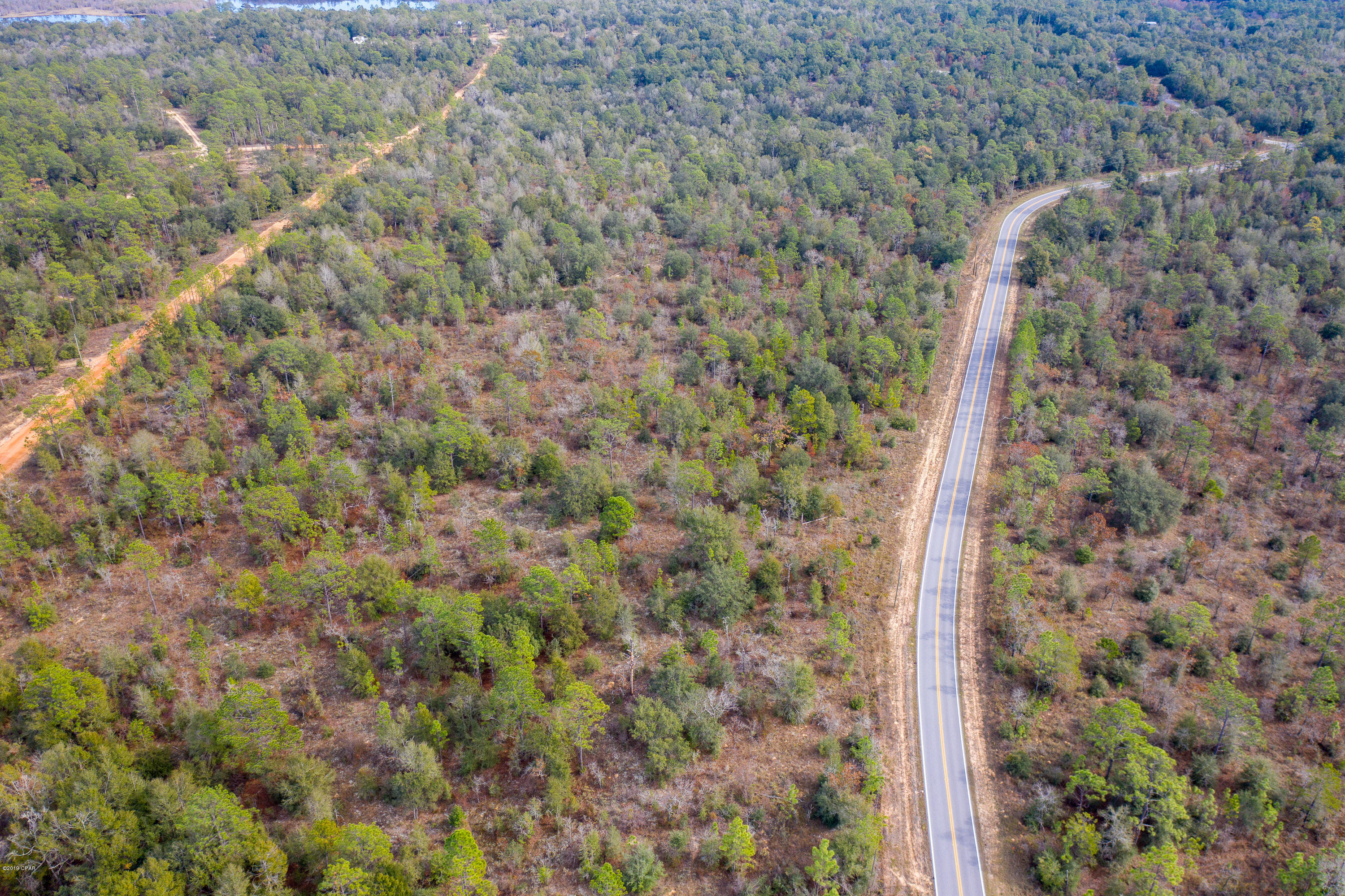 Pretty homesite on paved road gives you easy access to town, schools and the beaches.  Peaceful living at its best.  Come see, we won't mind.  Owner Financing available with 20% down.  Call for more details today.