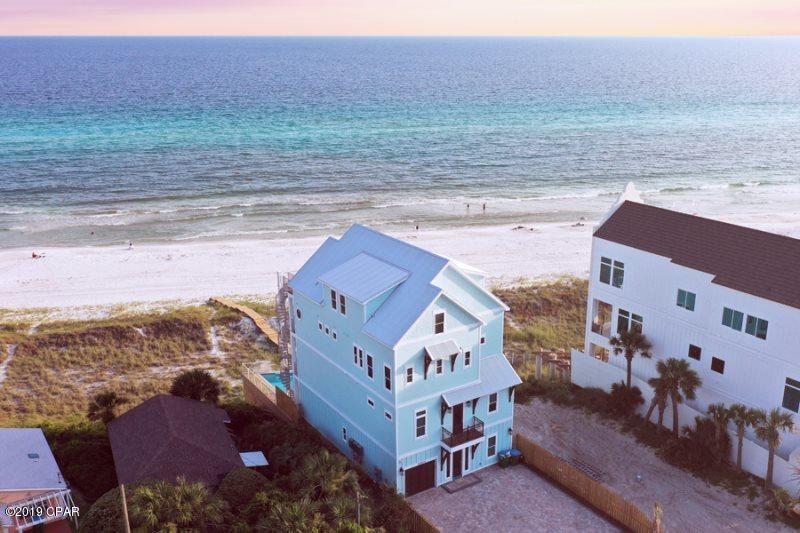 Unbelievable Beach House, largest one being built on Panama City Beach on one of the highest elevations of any lot on the Beach.  This house has it all, over 5964 square foot of conditioned air with 9 bedrooms, 9.5 baths, two living areas, two kitchens, rec room and over 1700 square foot of deck with a 37' infinity pool over looking a 30' elevation with a unrestricted view from any level.  In addition, the house has a garage and enough parking for 7 cars.  Totally designed for the large family retreat or a fantastic rental beach house that will sleep 30.  The house is custom decorated and will be ready to go and already on rental program with Holiday Beach Rentals.