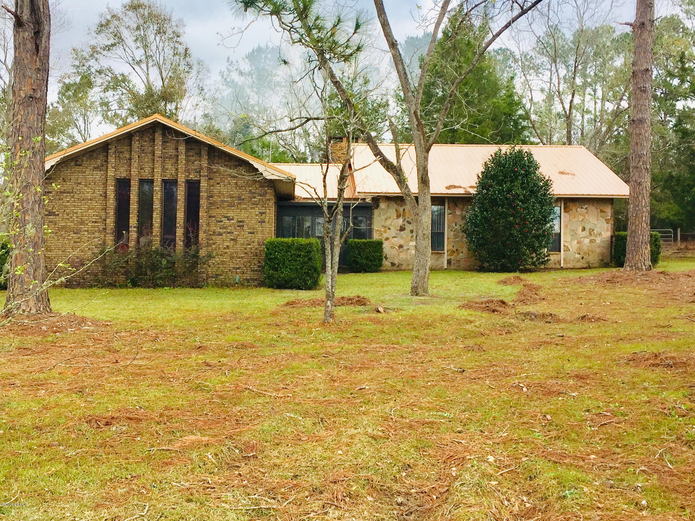 Your mini farm awaits! With fresh paint and new window treatments. This custom  home is move in ready! Bright and open eat in kitchen with porcelain tiles and load of cabinets. Tons of natural light. Sunken Great Room features beautiful hardwood floors, fireplace, recessed lighting and vaulted ceilings.. Spacious master bedroom with walk in closet and master bath. Florida room and large screened back porch offer nice transitions to the outdoor space.  This home has no hurricane damage. The farm is ready for your livestock with a chicken coop and pens already in place. Several nice spots for a garden also. 30 x 50 barn/workshop with concrete floors and electricity.  2 covered  RV pads. There is a small workshop that would need repair. Termite Bond and Home Warranty.