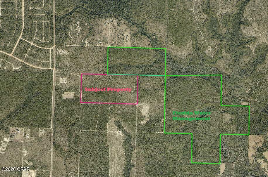 This property is essentially four asset classes in one:

1. A recreational property - Amazing deer, turkey and hog opportunities. Future off-grid hunting cabin which is grandfathered (exempt) from Florida building code.
2. A timber property - large amount of harvestable timber.
3. A working property -with AG1 zoning, property is currently under agricultural exemption which greatly broadens the opportunity.
4. An investment property- Electricity is available on each end of the property line. 
Welcome to Crystal Springs, an 80-acre high quality recreational property in North Bay County situated in the upper Econfina Creek sand hills aquafer. Located less than 1/2 mile North of the 41,363-acre Econfina Wildlife Management area, this property resides in the middle of the iconic sandhill uplands which is renowned for dozens of spring fed clear sand-bottomed lakes, ponds and creeks. These upland springs recharge the springs that feed Econfina creek. This property contains several of these aforementioned small springs along the creek as well as one beautiful spring that is nestled in the middle of a small pond which drains into the crystal-clear creek that runs the length of the Eastern property boundary. During wet seasons, this pond is truly amazing and rivals many of the famous Econfina spring swimming holes. During dry seasons, this pond which always has water, serves as an ideal lifesaving watering hole for hordes of thirsty wildlife. It is not uncommon to see over a dozen deer and turkey in the food plot surrounding the pond area. A 30-foot-deep manual well is situated near the pond spring and allows the owner easy access to extremely high-quality spring water without requiring any electricity to pump it. 
From the pond, creek, established food plots, neighboring landlocked water management land, upland pines and gorgeous hard woods, this is as 'park-like' and wildlife friendly as it gets. The game flow couldn't be better with one of the Panhandles' most iconic wildlife management areas just a stone thrown to the South and bordered nearly on 2 sides with additional Florida Water Management Land. The property has direct access to an additional 320 acres of land locked public land. 
The property has exceptional privacy and the current landowner has built an 16x26 on slab metal garage as well as a 25x 30 pole barn which will serve as the frame to rebuild the previous cabin which was damaged during Hurricane Michael. The cabin is a rare grandfathered off grid hunting cabin that has resided on the property prior to January 01, 2011 and is therefore exempt from habitable dwelling building code. The current owner has blueprint plans for the lofted off grid cabin reconstruction and will transfer with the sale.  
Property is situated either off Florida Highway 77 or 231 and is on a private drive at the far end of Elkcam Blvd in the Sunny Hills area.  Access via statutory private easement which also runs down the West and Southern property boundaries. There is no current conservation easement. Situated just 15 miles to shopping and restaurants in Chipley, Florida and just 40 min to shopping and restaurants in Panama City, Florida.

While putting in play the multiple options for future returns, Crystal Springs can offer you and your family outdoor recreational fun immediately.
