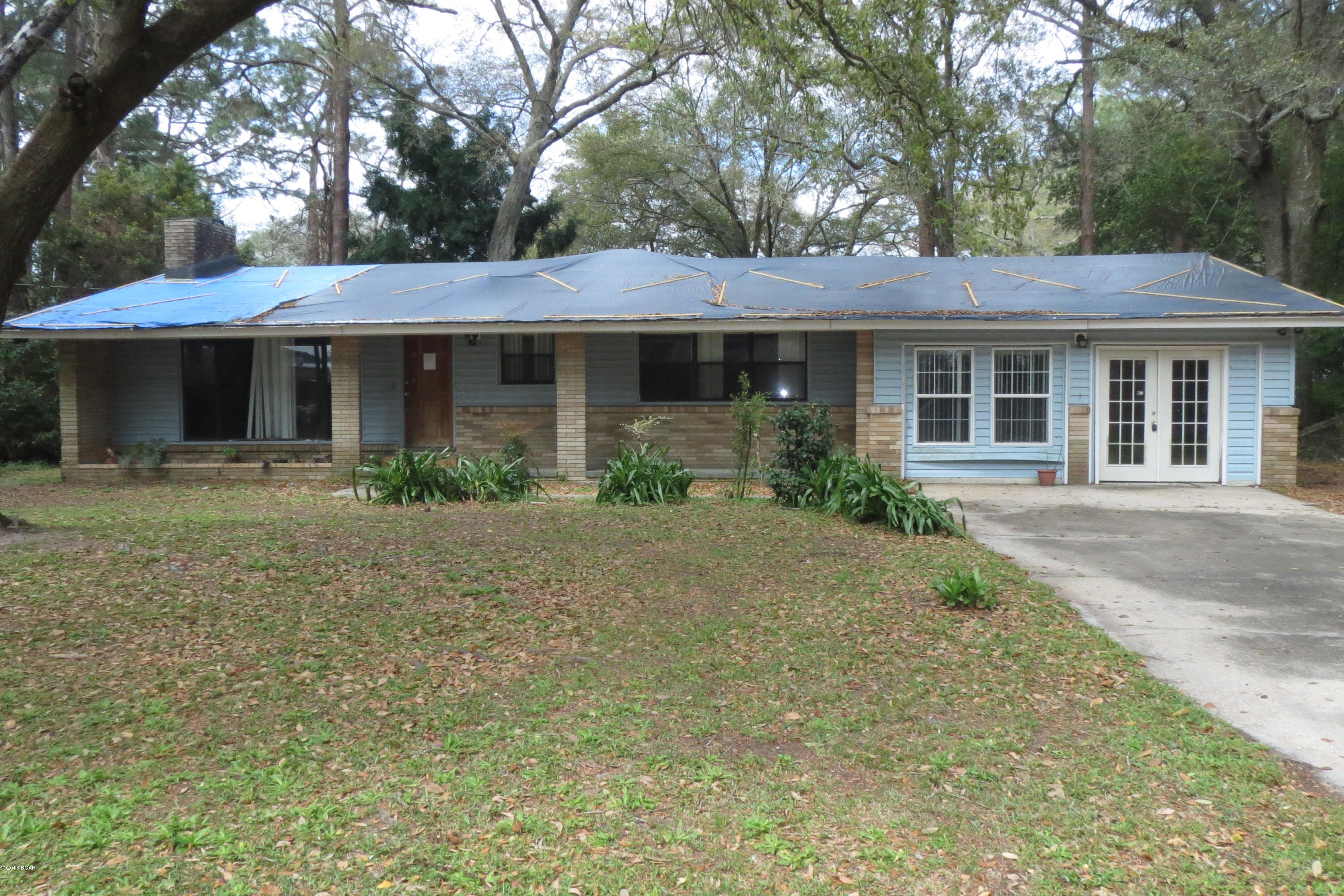 Centrally located home on a large lot!  The home features a living/dining room combination with a wall of built-in shelving, galley-style kitchen, and two bedrooms.  The garage has been enclosed to add a third bedroom and the laundry room is conveniently located nearby.  There is also a large utility room for additional storage.  Home being sold in its AS IS condition.