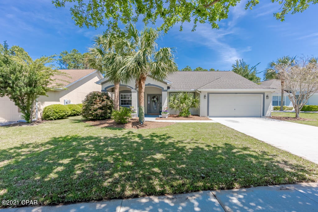 WOW! This home has been completely renovated to include new floors, baseboards, kitchen, bathrooms (to include toilets and faucets - exception is guest bathtub) all lighting fixtures, rear deck and sod (in front only). Exceptional  home with open floor plan, custom kitchen and bar sitting on a nature preserve located in popular 'Palmetto Trace.' 3BR/2BA, 1900+/-sf, custom closet built-ins, extensive 22'x14' patio, deck incl. outside shower, eat-in kit, huge family room, etc. Located across from Pier Park too! Palmetto Trace has two entrances with easy access to Hwy 98 or Hwy​​‌​​​​‌​‌​​​​‌​​‌​​​​‌‌ 79!
