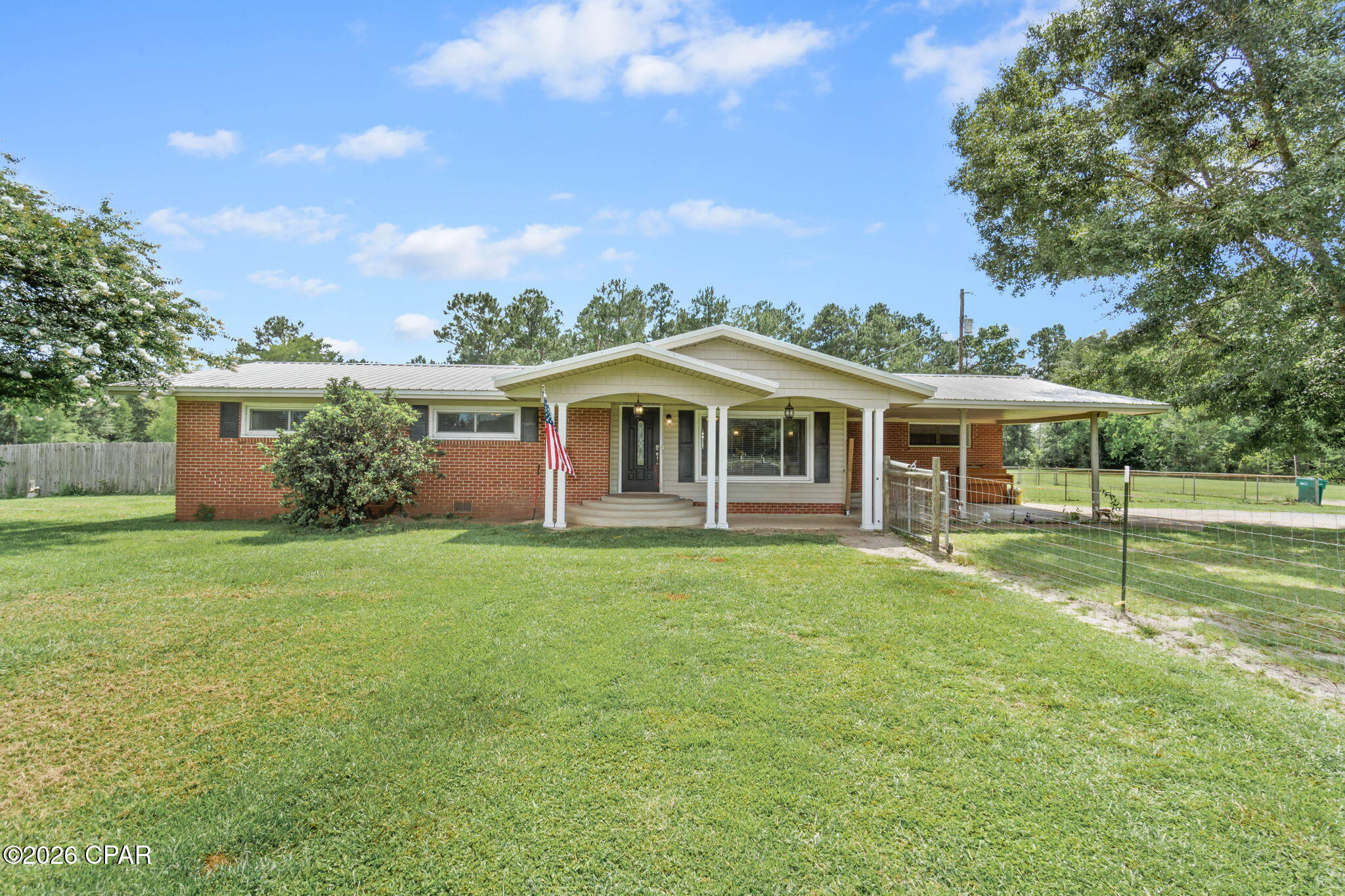 Don't let the age fool you on this beautiful, updated country 4/2 home that sits minutes from town. Offering a nice kitchen, dining area with gas fireplace, living room, spacious private master bedroom with access to covered patio, master bath with laundry, 3 additional bedrooms and a oversized hall bathroom with a walk in shower. There is a fenced in newer 14 x 20 salt water inground pool, 32x60 pole barn with electric and water. Home has updated metal roof, windows, and HVAC  The home is landscaped, has a storage shed and sits on 5 MOL acres. A bonus is a large pond and  paved road frontage.