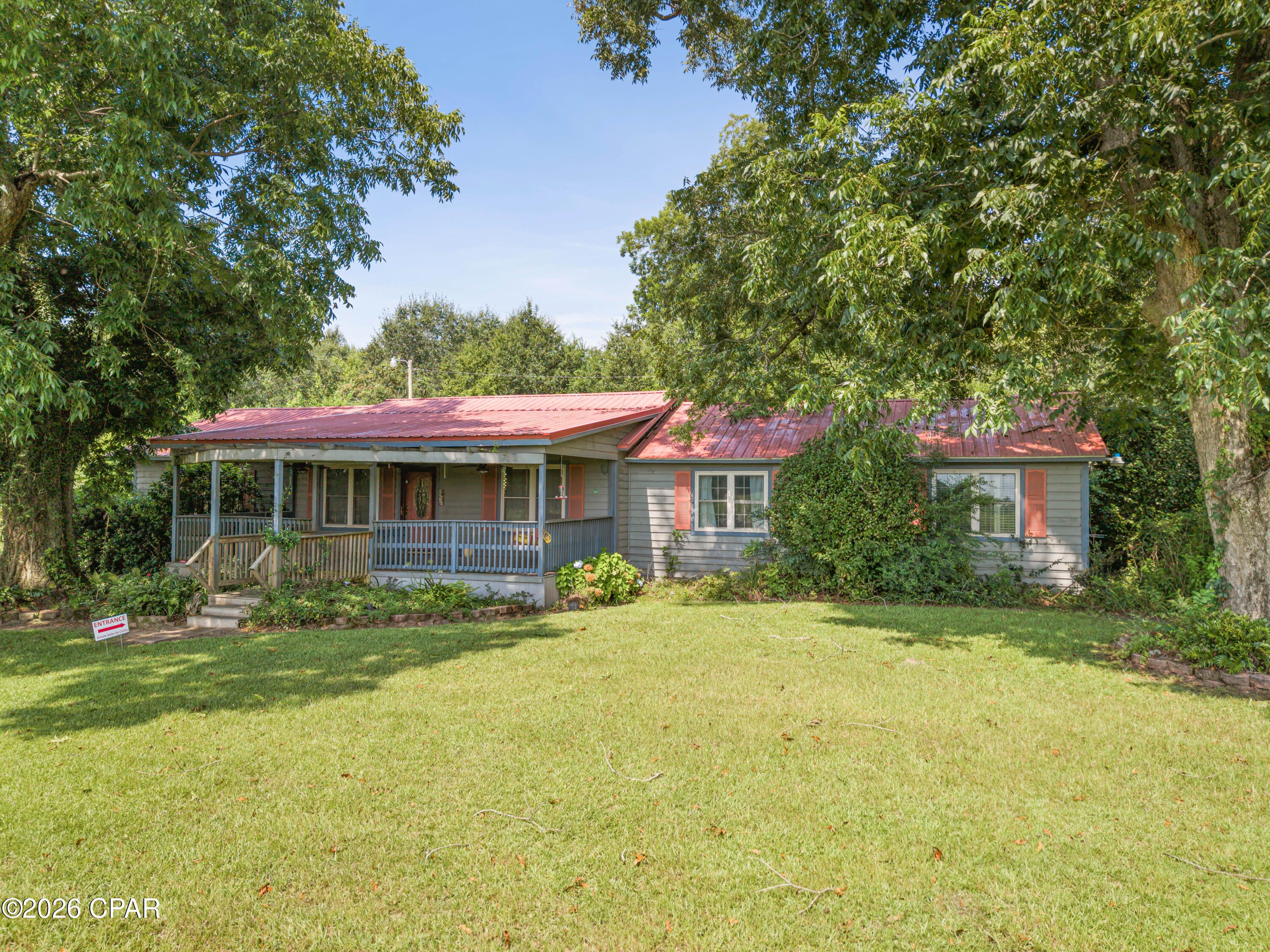 Welcome to peaceful country living just minutes from the charming town of Malone, Florida. Nestled in a quiet rural setting beneath beautiful mature pecan trees, this inviting 3-bedroom, 2-bath home offers the perfect blend of comfort, privacy, and outdoor enjoyment. Inside, you'll find a spacious layout featuring a large living room, a formal living room, and an open-concept kitchen, dining, and living area complete with granite countertops--ideal for everyday living and entertaining. A wood-burning fireplace adds warmth and character to the living space, creating the perfect spot to gather with family and friends. The oversized laundry room provides abundant space for multiple deep freezers, extra storage, or a hobby area. Both bathrooms have been upgraded, adding a fresh and modern touch to the home. Step outside and enjoy everything this property has to offer. A large front deck welcomes you home, while the fenced yard surrounding the home provides a safe place for pets to roam. Garden enthusiasts will love the separate fenced garden area with established fruit trees and raised beds, perfect for growing your own fresh produce. The property also features two functional wells, with one dedicated to the home and a second well providing water for the garden. The outdoor living spaces are just as inviting as the inside. Relax on the covered back porch or enjoy the enclosed back porch, which is perfect for plants, pets, or creating your own peaceful sunroom. A large carport provides convenient covered parking, while the utility shed offers additional storage for tools, lawn equipment, and outdoor essentials. This property truly offers the best of indoor and outdoor country living, with plenty of room for pets, gardening, entertaining, and simply enjoying the peace and quiet of rural life. If you're looking for a comfortable home with practical features, mature pecan trees, generous outdoor spaces, and plenty of country charm, this Malone property is ready to welcome you home.