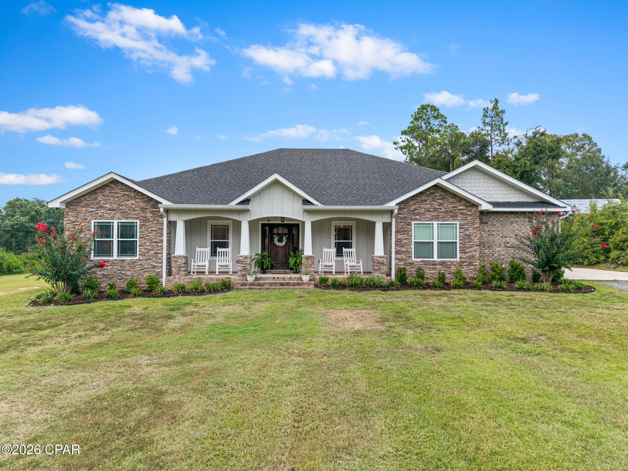 This stunning country home, located just 1 mile outside Bonifay city limits, sits on over 42 acres of picturesque land. It features four spacious bedrooms and three well-appointed bathrooms, with raised ceilings in both the living room and master bedroom. The open floor plan includes a beautiful kitchen adorned with granite countertops, a pot filler, and an abundance of custom-made cabinets, a pantry, a breakfast bar along with a separate dining area and an office complete with barn doors.  The spacious living room is highlighted by a gas log fireplace and double french doors that lead to a sunroom that overlooks the pool.  The master bath boasts dual sinks, a makeup vanity, a walk-in shower, and a luxurious jetted tub. Additional amenities include can lighting with LEDs, a Rinnai hot water heater, and a large laundry room with a utility sink and there is a double car carport convenient for the rainy days. With an asphalt driiveway. Outdoors, the property features a 36 x 36 Gunite inground pool with a waterfall and tanning ledge, palm trees, pavers surrounding the pool, 5-foot aluminum security fence and a 12 x 12 pergola that's perfect for outdoor gatherings and grilling. For extra storage there is a 36 x 36 pole barn to store boats, ATVS and lawnmowers etc,  The fun part is there is ATV trails around entire property, food plots, and an abundance of wildlife. Along with paved road frontge. This home offers a perfect blend of luxury and country living!