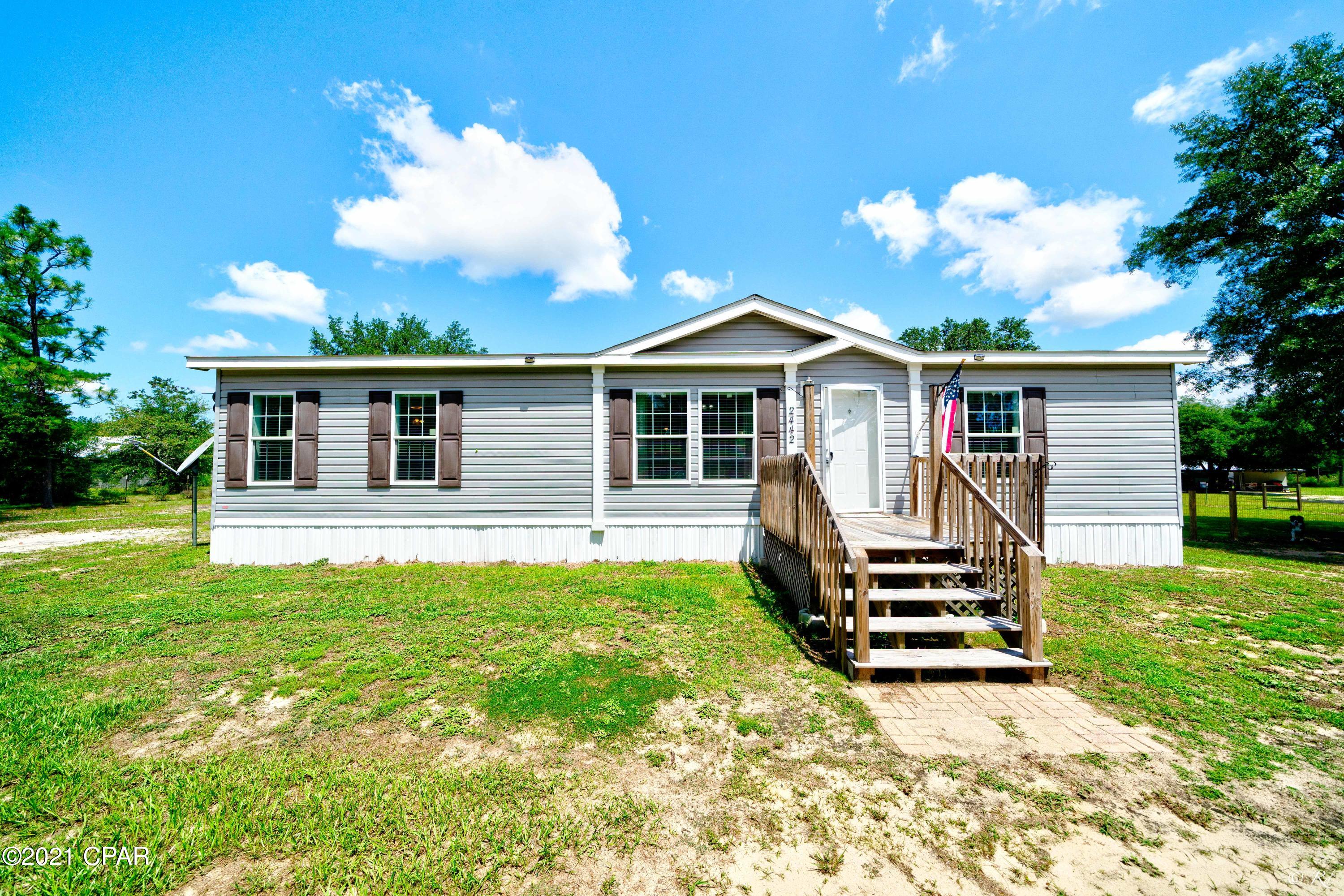 3 bed, 2 bath mobile home with a split floor plan located in the quiet Grassy Pond Ranch community.  The open living/dining area features carpet throughout and two-tone paint with a decorative chair railing. The home is equipped with wood-like vinyl throughout the main areas. The eat-in kitchen features a breakfast bar, stainless steel appliances,  and a hide-away pantry. The master bedroom boasts its own private ensuite.  The private master bathroom boasts a his/her sink, a large garden tub, and a walk-in shower.  The two guest bedrooms with walk-in closets share a bathroom with a shower/tub combo and a Transom window. This home boasts a large back deck and lean-to shed for extra storage.  This home also features over 3 acres of land in a quiet neighborhood for you to enjoy and add to. The HOA fees cover road maintenance for your convenience. You don't want to miss out on this charming home for your family!